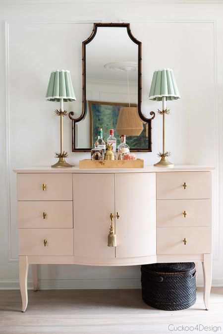 Love this little corner of my dining room with the blush sideboard, gold thin lamps, fluted lampshades, burlwood tray, and unique black and gold mirror

#LTKStyleTip #LTKSaleAlert #LTKHome