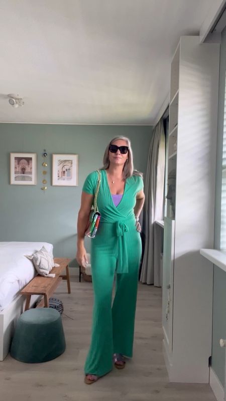 30 days of summer outfits. A tall green surplice jumpsuit that is just the softest thing ever. Worn over a lilac glitter bikini top. Paired with lilac metallic sandals, a rainbow bag, NYX tiramisu lipgloss and oversized sunglasses. 

#LTKstyletip #LTKeurope #LTKSeasonal