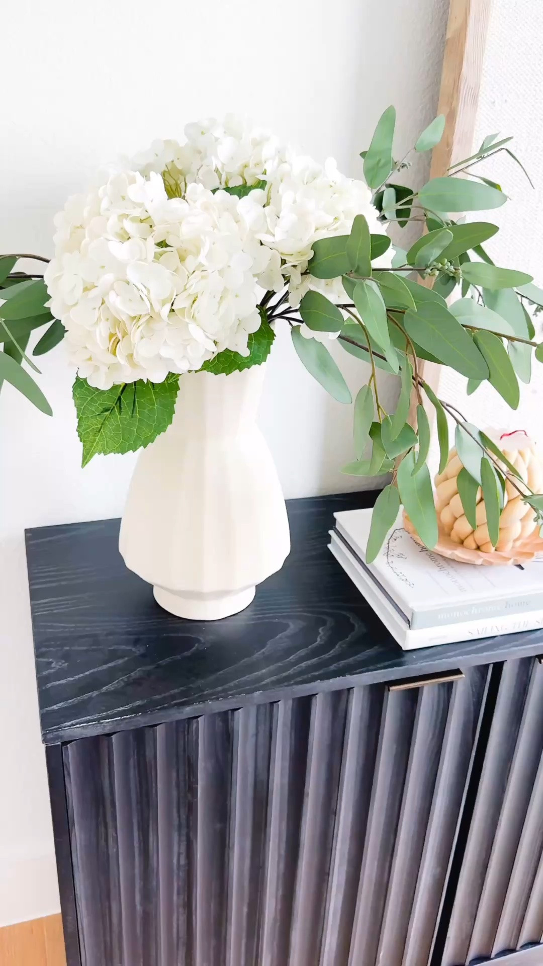 Designer-inspired console styling that instantly elevates a room. This fluted black console is currently on major sale I paired it with oversized neutral artwork, coffee table books, sculptural decor, greenery, and warm lighting creates a timeless modern organic look. Sharing my favorite console table decor, neutral home styling finds, modern home decor, entryway decor inspiration, living room styling ideas, designer look for less furniture, faux realistic hydrangeas, luxury home aesthetic, organic modern decor, elevated home styling, and affordable designer-inspired finds.

#LTKHome #LTKSaleAlert #LTKSeasonal