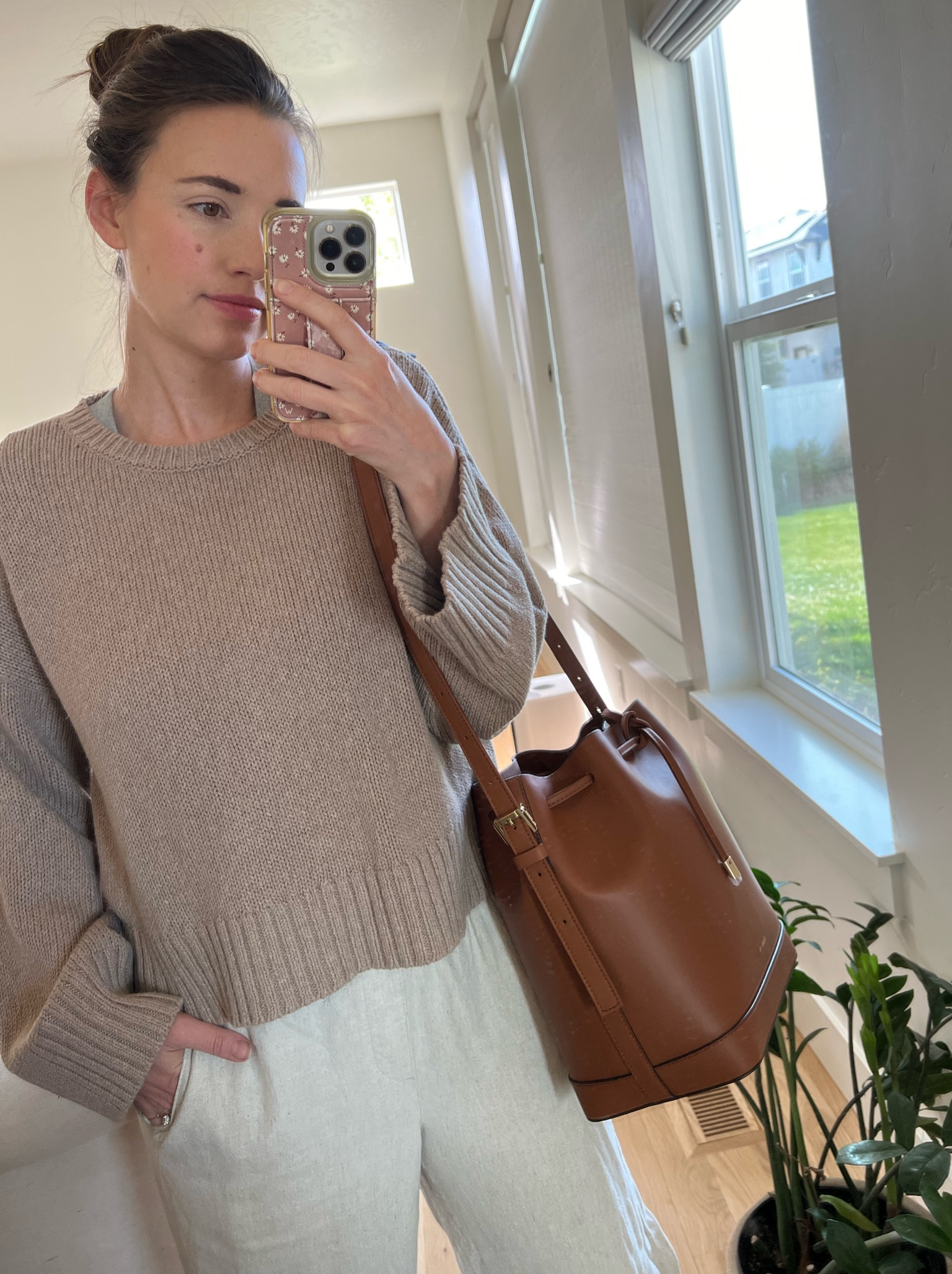 Knit Jenni kayne sweater and linen pants with leather bucket bag. Spring outfit inspiration  