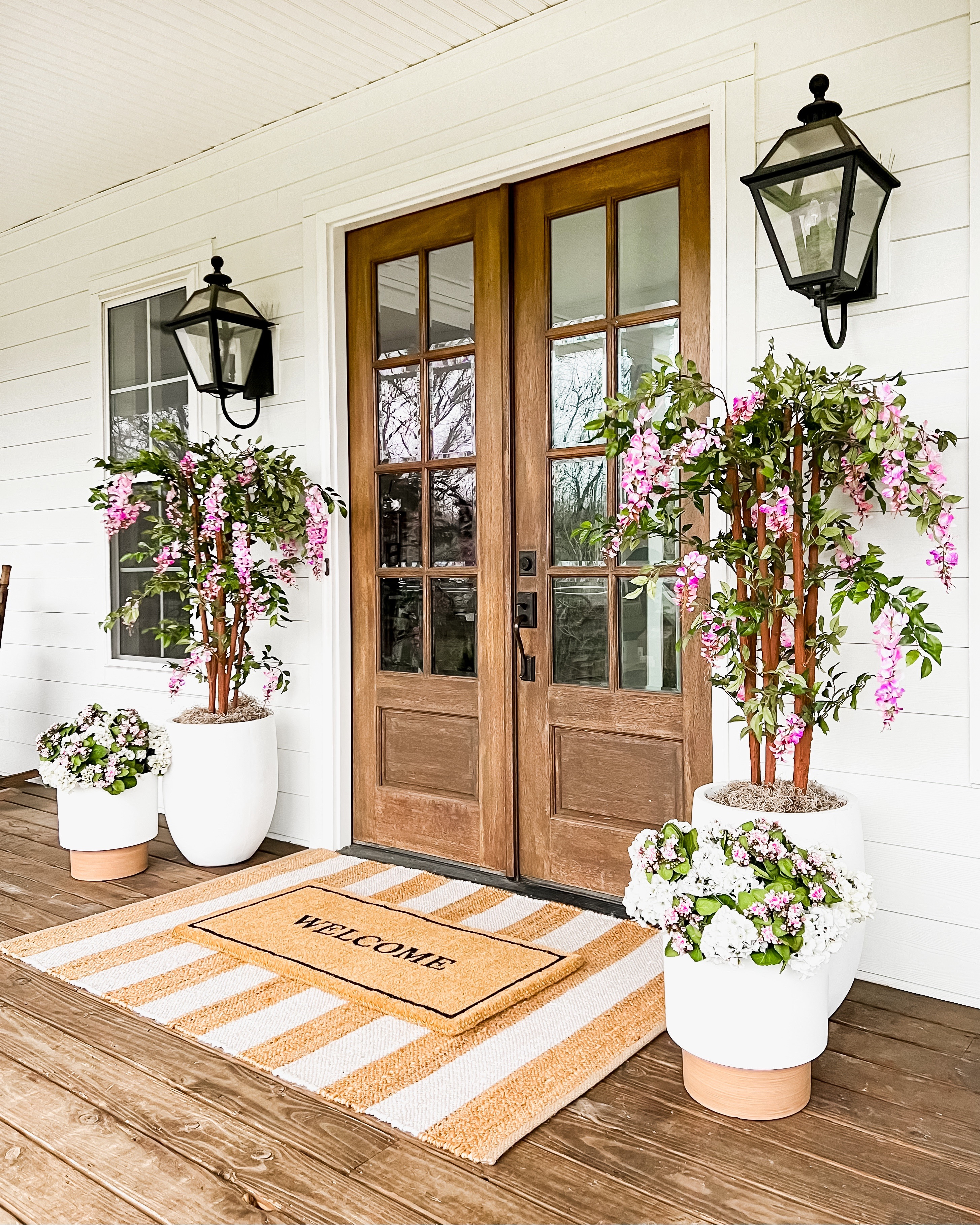 One of my fave spring/summer porches! I love the pops of pink and seeing these wisteria trees blow in the breeze!

#LTKHome #LTKSeasonal #LTKSaleAlert