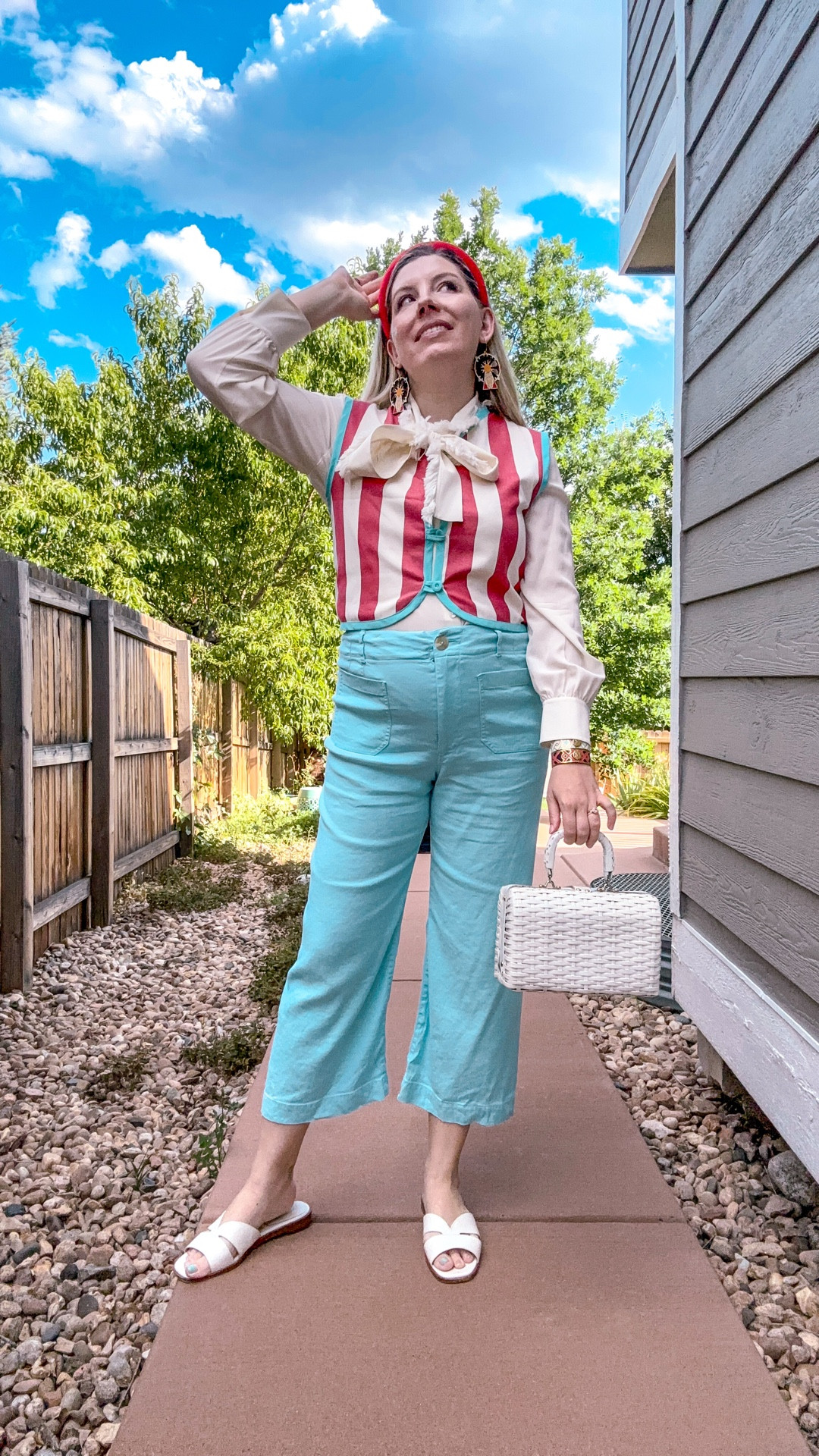 Look 20
Coastline Calling
🎟 Step right up… to my favorite look yet.

These Ferris Wheel earrings are SO GOOD. They are so fun to style and really lightweight and comfortable - check out these and more from this amazing woman-owned brand linked on my LTK .

This outfit is giving retro carnival, Riviera resort, and vintage prep all at once. The striped vest, oversized bow, and Ferris wheel earrings bring the drama, while the pastel pants and basket bag keep things comfy and wearable.

Part of Coastline Calling—my summer capsule of maximalist style, seaside nostalgia, and bold details you can wear anywhere (even landlocked). Save this for outfit inspo and follow along—new looks drop daily!

Earrings - Le Chic Miami (linked)
Vest - La Veste
Pants - Anthropologie (current colors linked)
Top - Tory Burch (similar linked)
Headband - TJ Maxx (similar linked)
Bracelets - Spartina 449 (linked)
Shoes -Kate Spade (similar linked)
Rings - Dillards (linked)
Fragrance - Capri summer, Skylar (linked)

#ad #lechicmiami
#CoastlineCalling #RetroResortwear #MaximalistStyle #SummerCapsuleWardrobe #StatementAccessories #ColorfulStyle #PreppyStyle #VintageInspired #NauticalWithATwist #LTKStyle #StyledMyCloset #CarnivalChic #PlayfulFashion #BoldSummerLooks #CoastalCool #CapsuleWardrobeSeries #StatementEarrings #WovenBagTrend

#LTKSeasonal #LTKStyleTip #LTKFindsUnder50