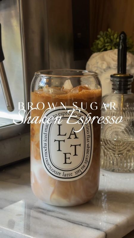 If you are a coffee lover and enjoy the Brown Sugar Shaken Espresso from Starbucks, recreate it at home 🤎

BROWN SUGAR SHAKEN ESPRESSO

➖Pull a double shot of espresso. I use the @breville Barista Express (I love it!)
➖Combine ice, espresso, tablespoon of brown sugar, and dash of cinnamon in a cocktail shaker 
➖Shake well
➖Pour over your milk of choice and ice

Enjoy! 🧊☕️👌🏼

Coffee recipes // kitchen coffee bar // coffee accessories // breville espresso machine // iced coffee at home

#LTKHome #LTKVideo #LTKFamily