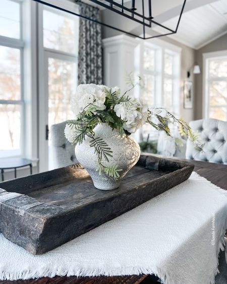 A large tray and faux flowers in a pretty vase on a table throw creates a statement dining table centerpiece. 

Home decor, spring decor. 

#ltkstyletip

#LTKFind #LTKSeasonal #LTKhome