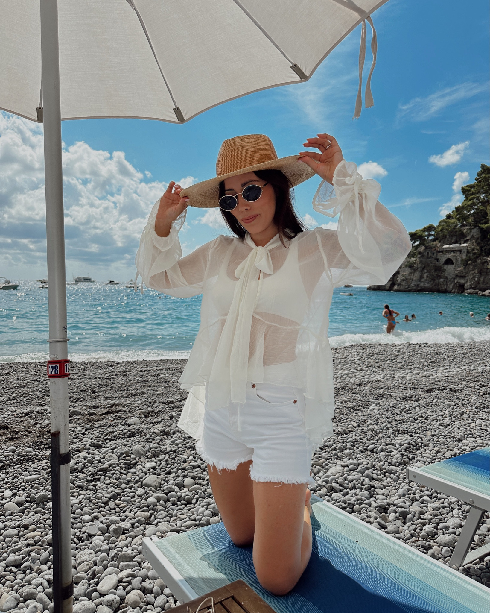 Autumnal beachwear a thing? Well it needed to be for our mid-September little honeymoon because the weather report showed a mixture of sun, clouds, rain and wind. So a sheer (very Chloe-esque) long sleeve pussy bow blouse with some casual white high waisted shorts and a wide brim hat was the look for this perfect beach day in Positano (see my insta @sable_amanda for all the locations!). 🤠🇮🇹🤍

Top: Stradivarius
Bikini: Oysho
Shorts: Zara
Hat: Lack of Color
Sunglasses: Parfois
Slides: Zara
(Linking similars!) 

#LTKTravel #LTKSwim #LTKWedding