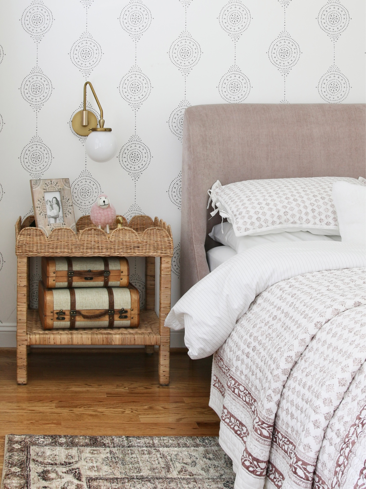 Here is a better view of the scalloped side table. I styled it with decorative wood storage chests. Above the side table is a swing arm  bedside wall sconce. Luna striped wallpaper completes the look

#LTKstyletip #LTKFind #LTKhome