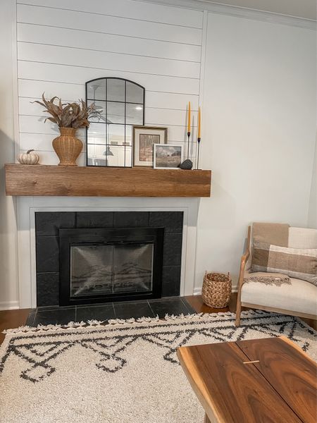 Fireplace.  Family room.  Neutral home.  Rugs USA 8 X10 Moroccan Area rug.  Black arched mirror.  Target style home.  Oatmeal linen armchair by Threshold.  Target basket.  Target wicker vase.  Black candlesticks.  Fall lumbar pillow.  Cashmere throw by Standard Textile.  Ceramic pumpkin.  

#LTKstyletip #LTKSeasonal #LTKhome