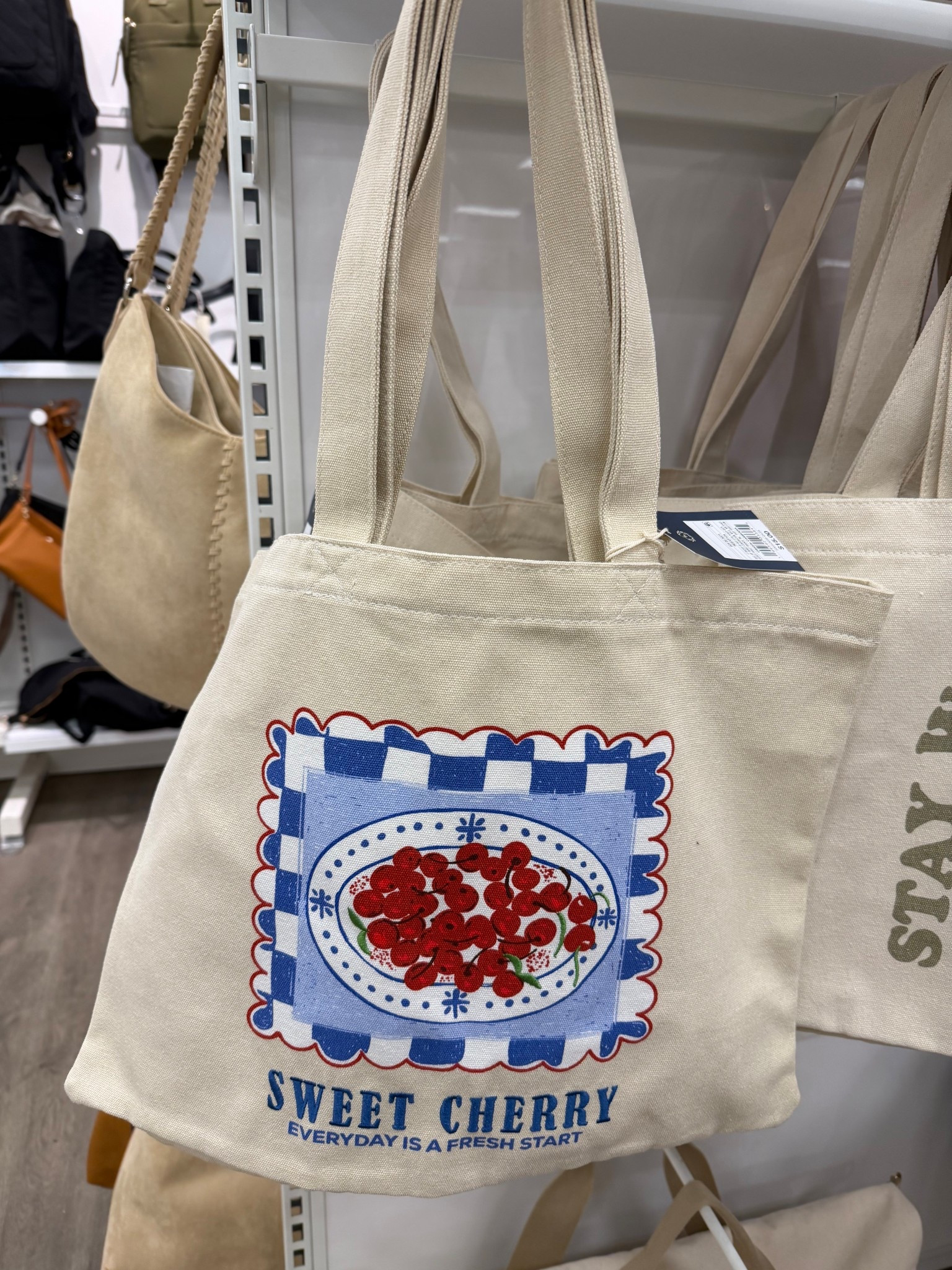 Sweet cherry Universal Thread magazine tote handbag. Made with recycled cotton canvas fabric. Features an open top and has Double shoulder handles. #canvastote #totebag #bag #everydaycarry 

#LTKMothersDay #LTKgrwm #LTKootd