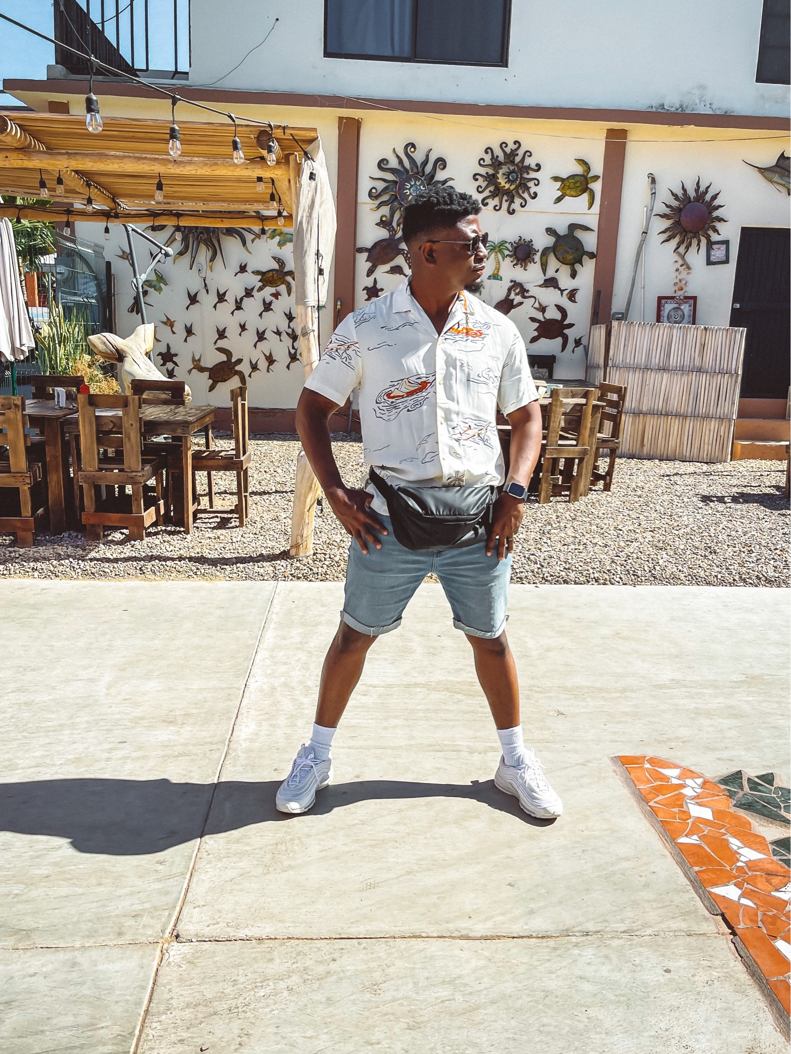 White air max sneakers, graphic short sleeve button up, blue Jean shorts, sunglasses black Fannie pack 

#LTKtravel #LTKshoecrush #LTKmens