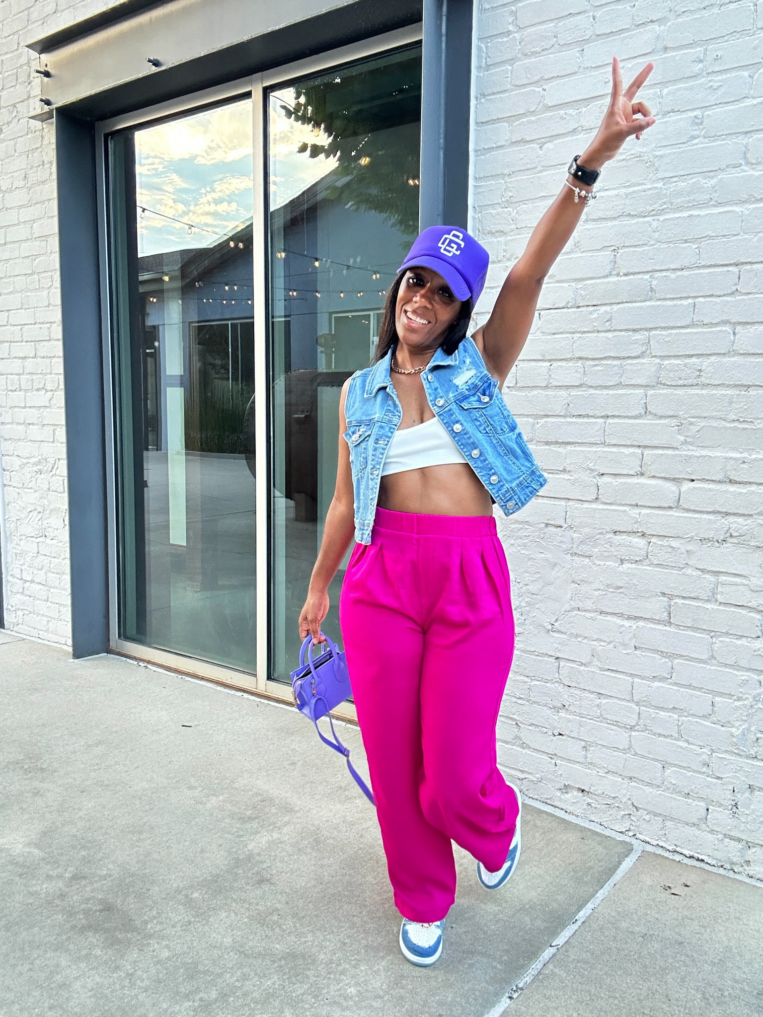 How to style a denim vest.

I’m wearing a white camo crop top with hot pink trouser pants.

I styled this simple outfit with a pop of color, purple trucker hat and purple mini crossbody bag.

#LTKStyleTip #LTKFindsUnder50 #LTKSaleAlert