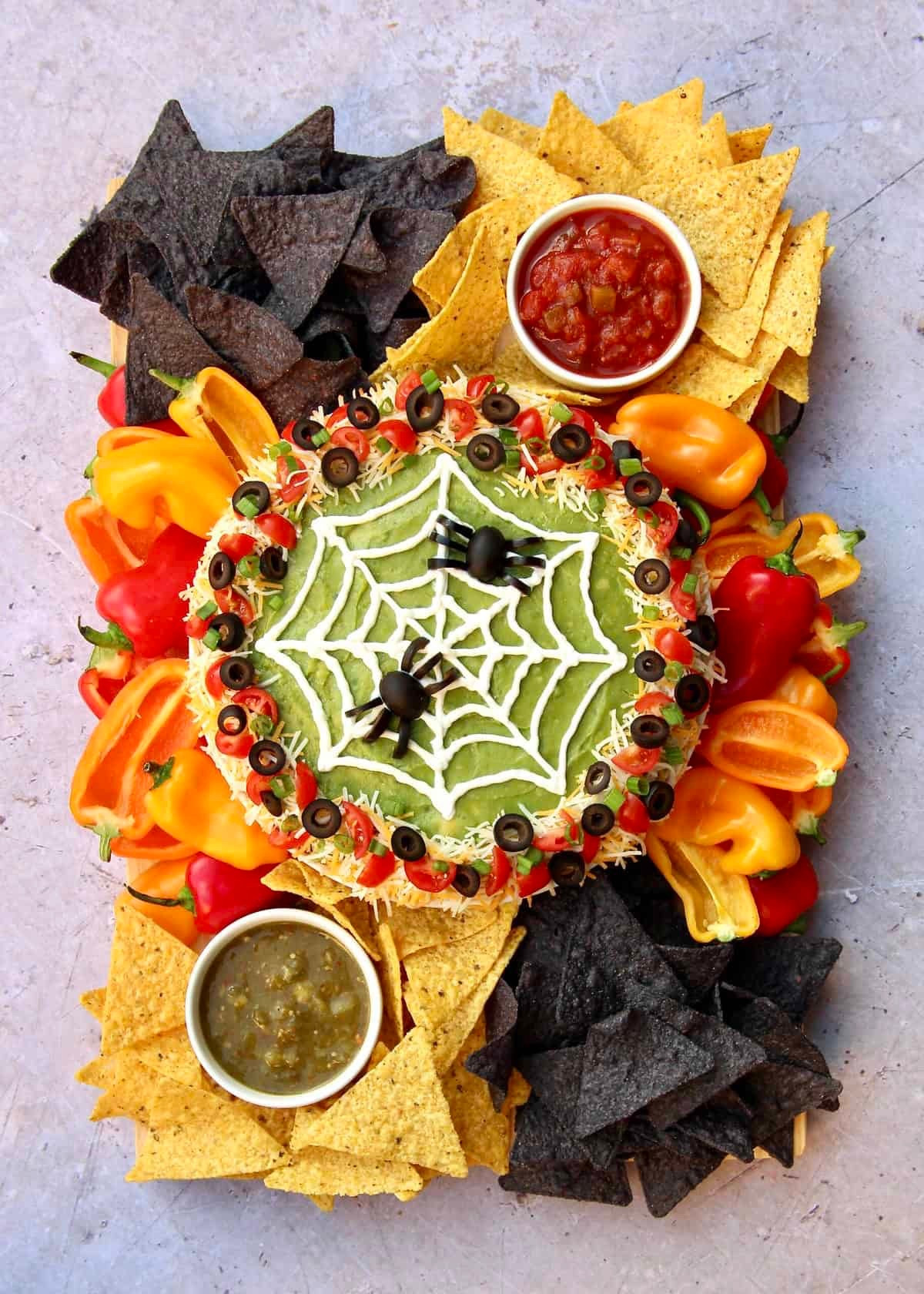 Take your party snacks to haunting new heights with my easy-to-make Spiderweb Seven Layer Dip Board! With black olive spiders and a sour cream web, this super spooky twist on a favorite will leave your guests in awe!

#LTKautumn #LTKFamily #LTKParties