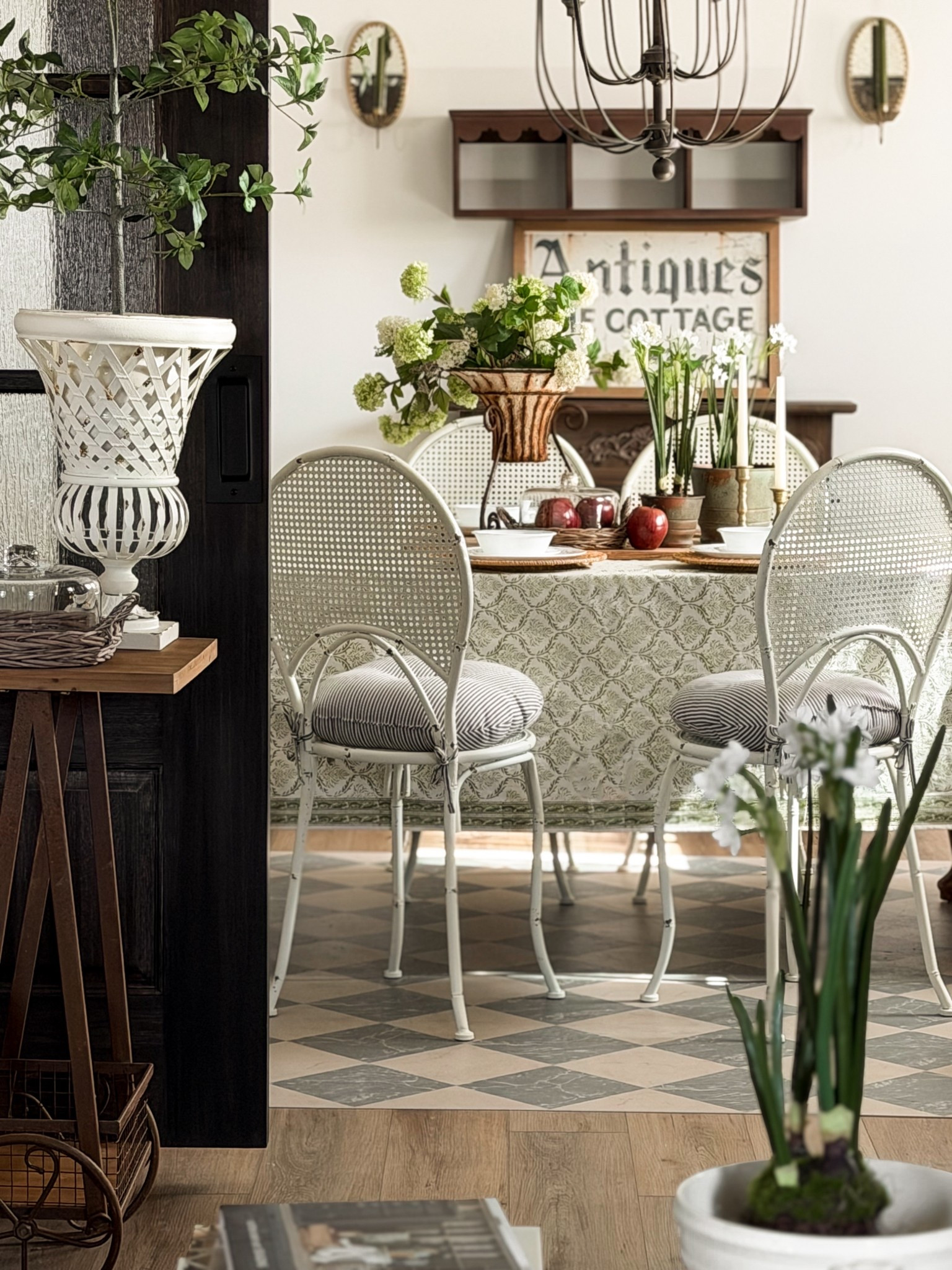 A quiet little peek at the formal dining room before the wallpaper goes up. 🙌🏼

This space has slowly become one of my favorite rooms in our home. The darker doors, the checkered floors, the cane metal chairs, the layered greens. It already feels collected & I can see the next layer so clearly.

I’ve always believed rooms evolve in chapters. You live in them first. You style them. You adjust the light. You pay attention to what they’re asking for. And then, when the timing feels right, you add something bold.

Wallpaper is next.

For now, I’m soaking in this calm, classic moment. The brass candlesticks, the vintage inspired tablecloth, soft florals, & simple place settings that make even an ordinary evening feel intentional.

Builder grade to cottage character, one layer at a time.

Tell me… are you a wallpaper lover or do you prefer painted walls friend? 🤍 xo, Krystle | tablecloth from: @cottonprintclub  | chairs from @decorsteals | chandelier from: @antiquefarmhouse |

#LTKHome #LTKSeasonal