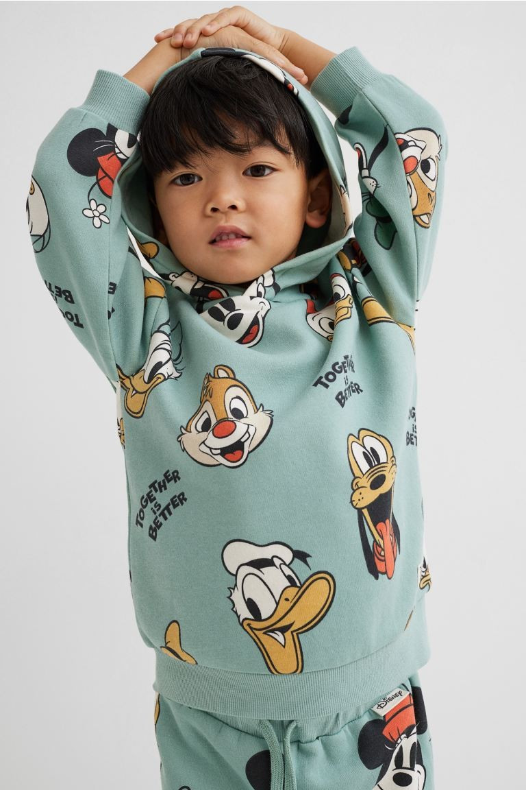 Disney x H&M. Cozy sweatshirt hoodie with a printed pattern and soft, brushed inside. Jersey-line... | H&M (US + CA)