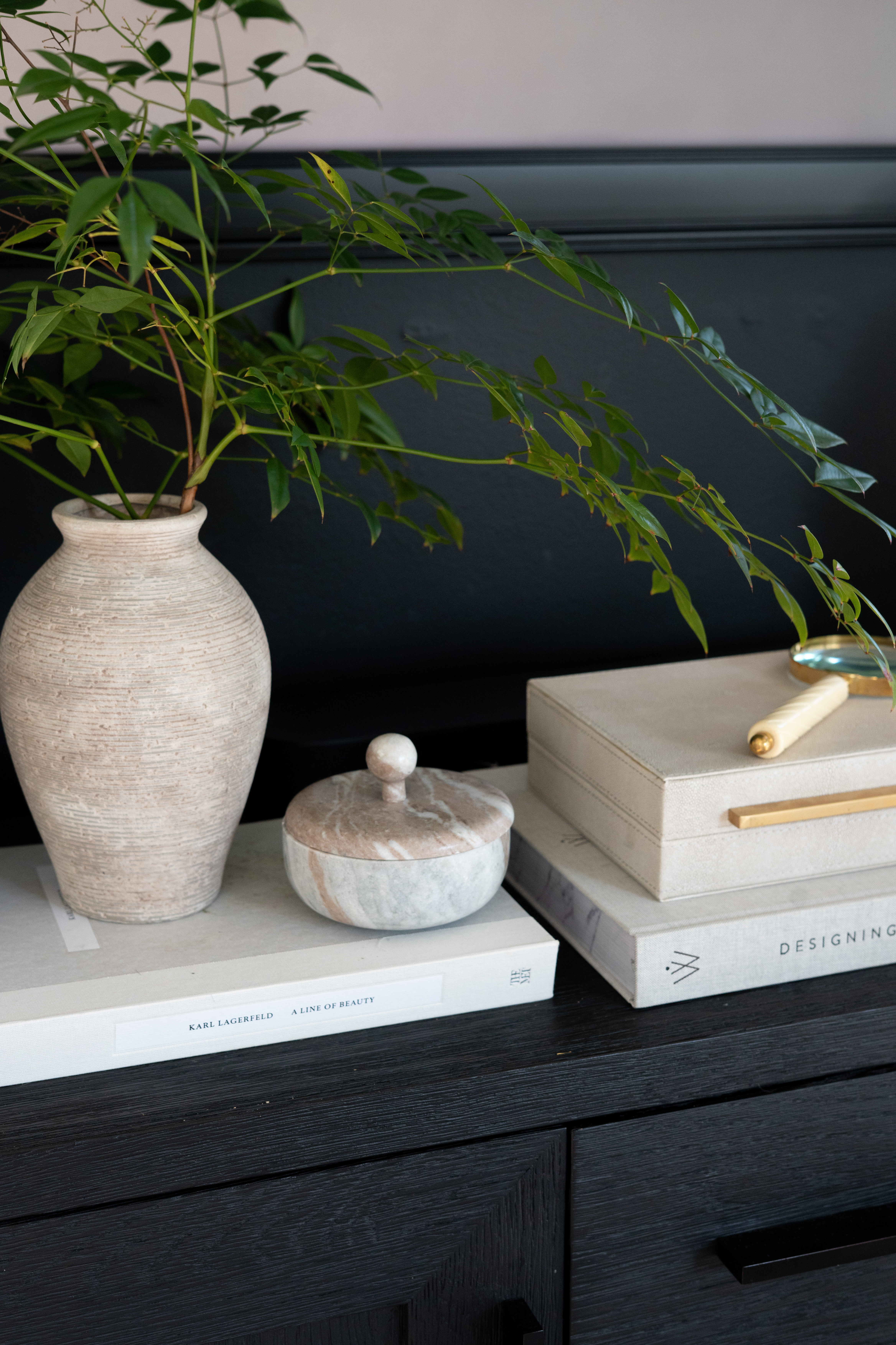 It’s the quiet little styling moments that make a room feel complete. A simple vase of natural greenery from the yard, stacked design books, soft marble accents, and warm brass details create the most calm and elevated corner. I love how the natural textures and dark wood tones make this space feel so grounded and beautiful. 

 #LTKSpringSale #LTKSeasonal #LTKHome