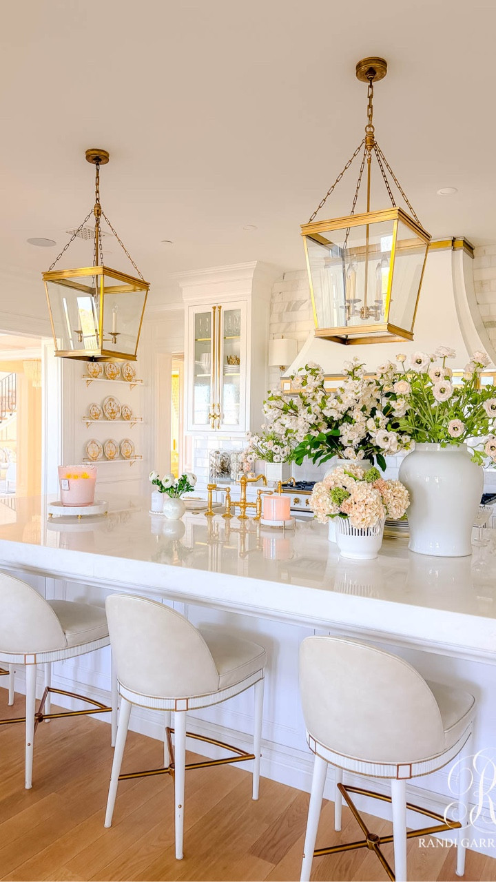 How I dressed my kitchen island for spring!

I started with classic white ginger jars and filled them with faux peachy pink ranunculus ( I used 8 stems), airy cherry blossoms ( I used 8 stems) with a few faux leaf stems (I used 2 stems) and soft peach hydrangeas (I used 2 sets) mixed with these green florals and pink florals (I used 1 set of each) arranged in a French cache pot. The mix feels collected and effortless — like something you’d stumble upon in a charming countryside kitchen.

Sitting on the other end of the island is a giant five-wick Panjore Lychee Candle — it smells absolutely incredible and makes such a statement on a beautiful marble tray (currently on backorder, but here is a lovely alternative).

#LTKSeasonal #LTKHome