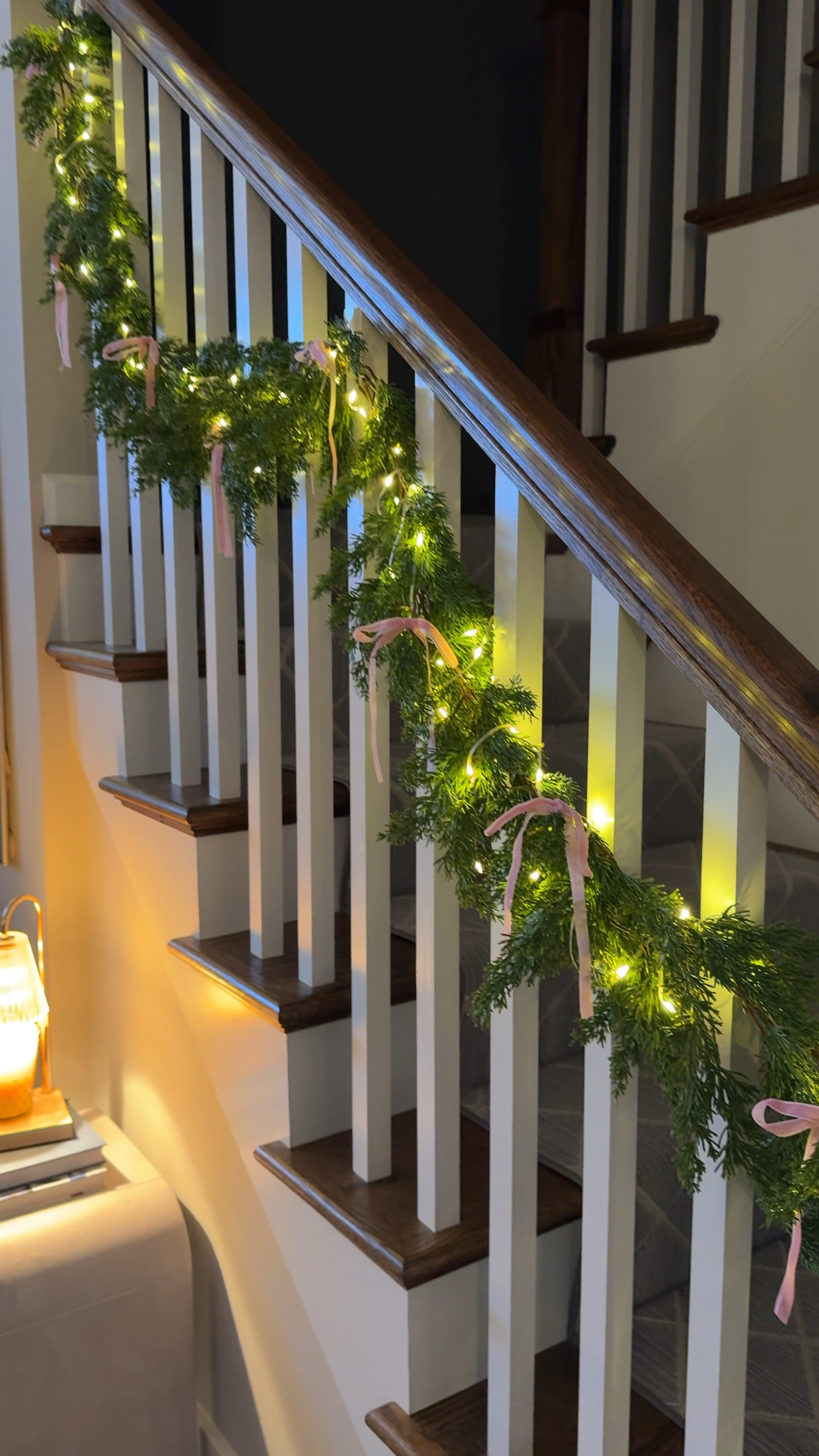 This garland from Amazon is soooo good and realistic without the mess of pine needles AND it comes with LED lights. I added cute pink twist on velvet bows and attached them to our banister with command hooks 🎀

#LTKHoliday #LTKHome #LTKWatchNow
