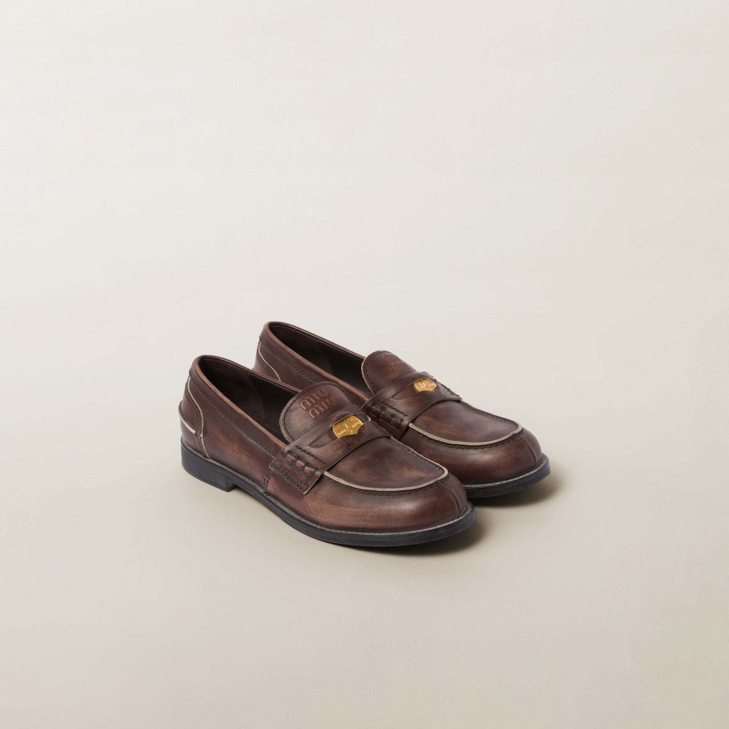 Ebony Vintage-effect Leather Penny Loafers | Miu Miu | Miu Miu US
