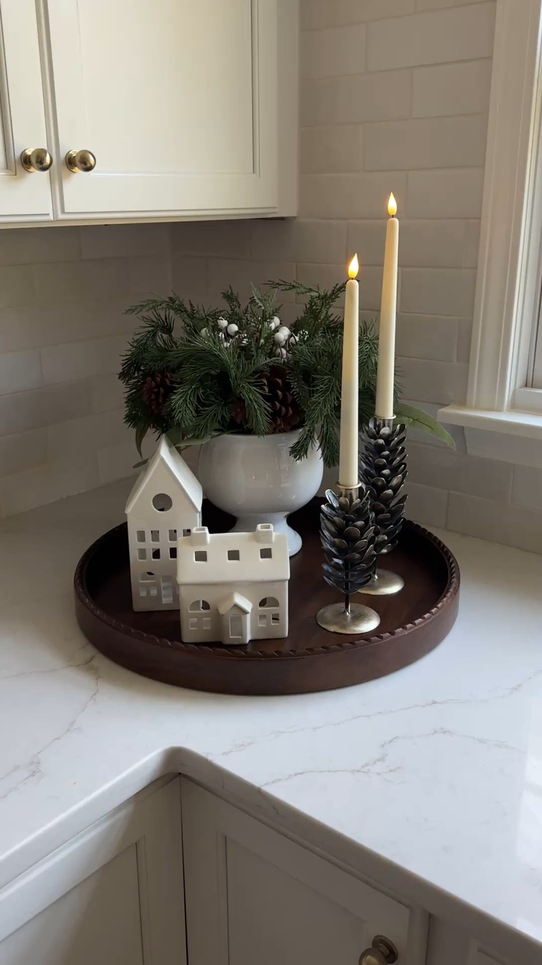 Less clutter, more cozy. ✨ We added just a few winter touches ceramic houses, pinecone taper holders, and fresh greens  and it completely changed the feel of this corner.

#LTKSeasonal #LTKHome