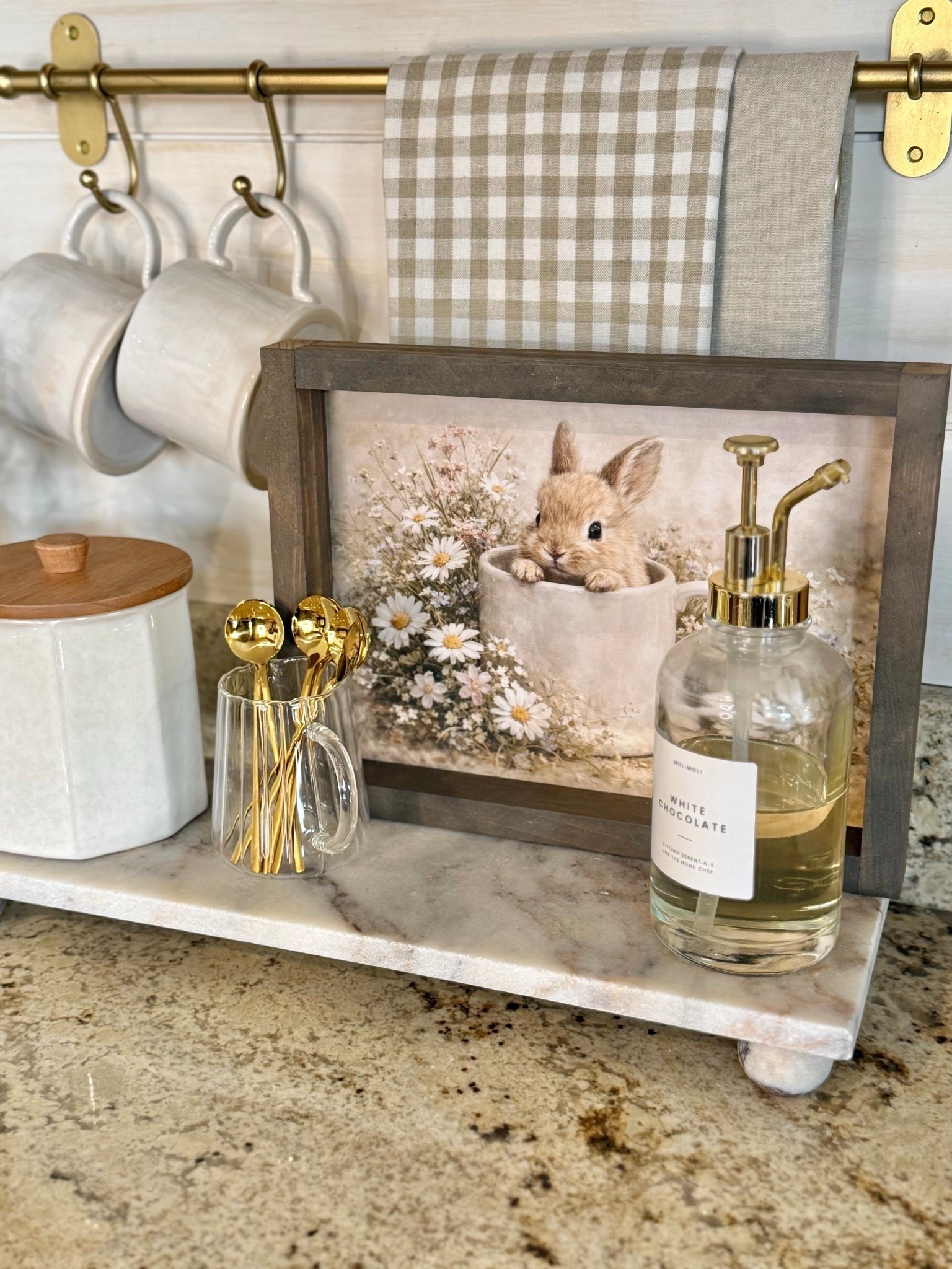 Spring | Easter Coffee Bar 

Follow @farmtotablecreations on Instagram for more home styling ideas and daily deals.

Follow along as I style the cutest piece of spring artwork from my sweet friend Brittany @currentlychic. The Bunny’s Morning Brew is shown here in the 9x12 size with the Briarsmoke stained frame, and it adds the most charming seasonal touch to this little coffee bar moment.

I paired it with neutral mugs (that perfectly match the one in the artwork), softly layered tea towels, a set of gold spoons for a warm, collected feel, and a bottle of syrup to make those morning cups feel a little extra special. It’s such a simple way to bring a little Easter charm into the kitchen while keeping everything light, cozy, and neutral enough to enjoy all season long.

Use code FARMTOTABLE to save 15% off artwork.
Four stems in vase.

#coffeebar #springdecor #easterdecor #springrefresh #springcoffeebar #kitchen #counterdecor #springcoffeebar #eastercoffeebar




#LTKSaleAlert #LTKSeasonal #LTKHome