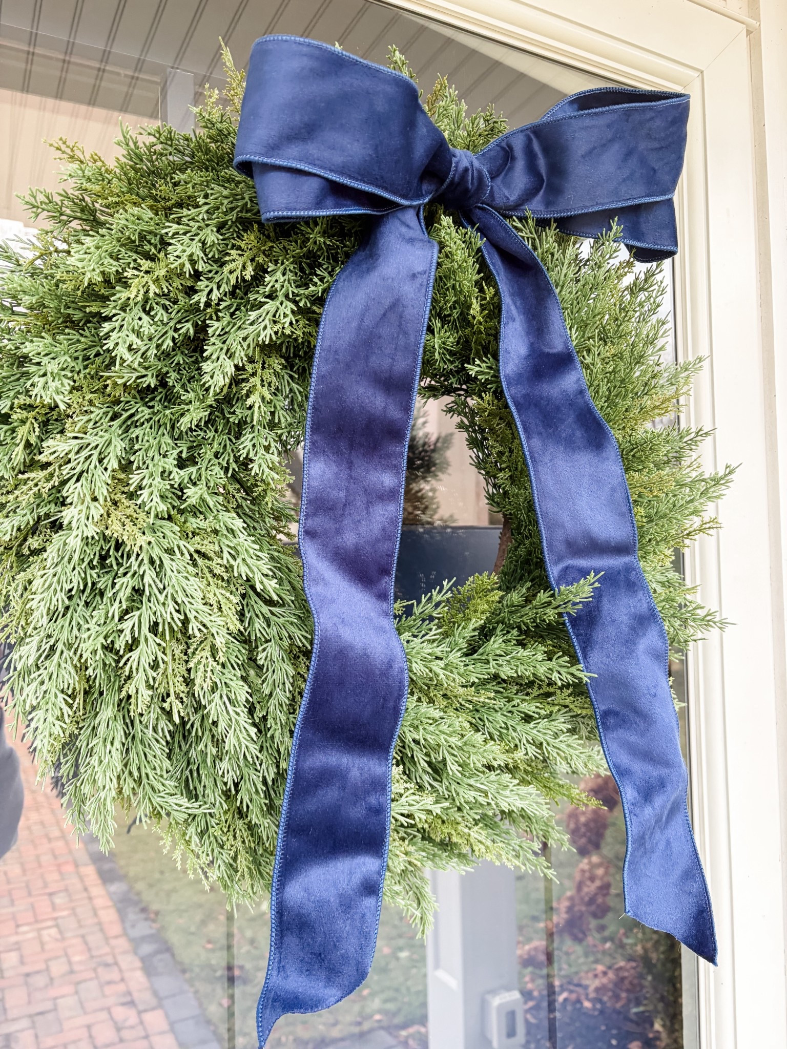 A wreath for after Christmas!  This Amazon wreath looks real but it is faux.  I added a navy blue wired, velvet ribbon to match my house. 

#LTKHome #LTKFindsUnder50