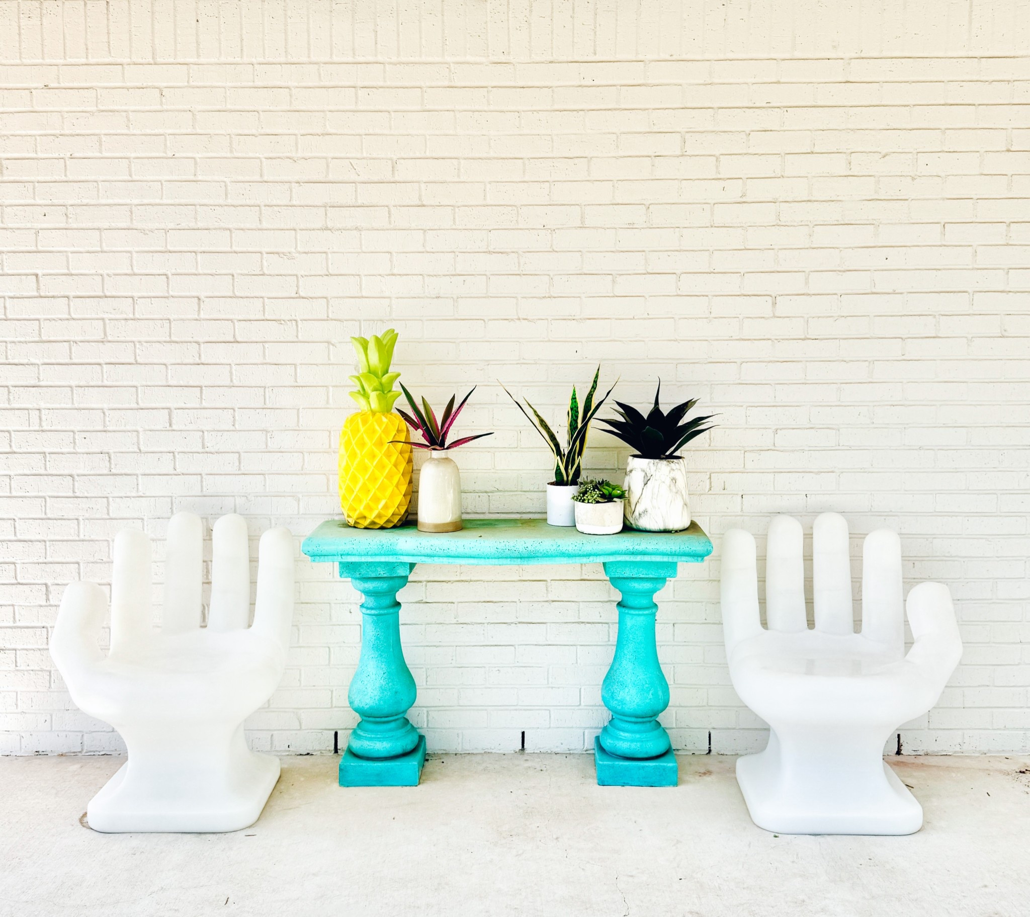Outdoor pops of color! I spray painted this faux stone table, the hand chairs are so good! Also this pineapple is huge and the cutest!  Loving the colorful patio decor!!

#LTKHome #LTKSeasonal