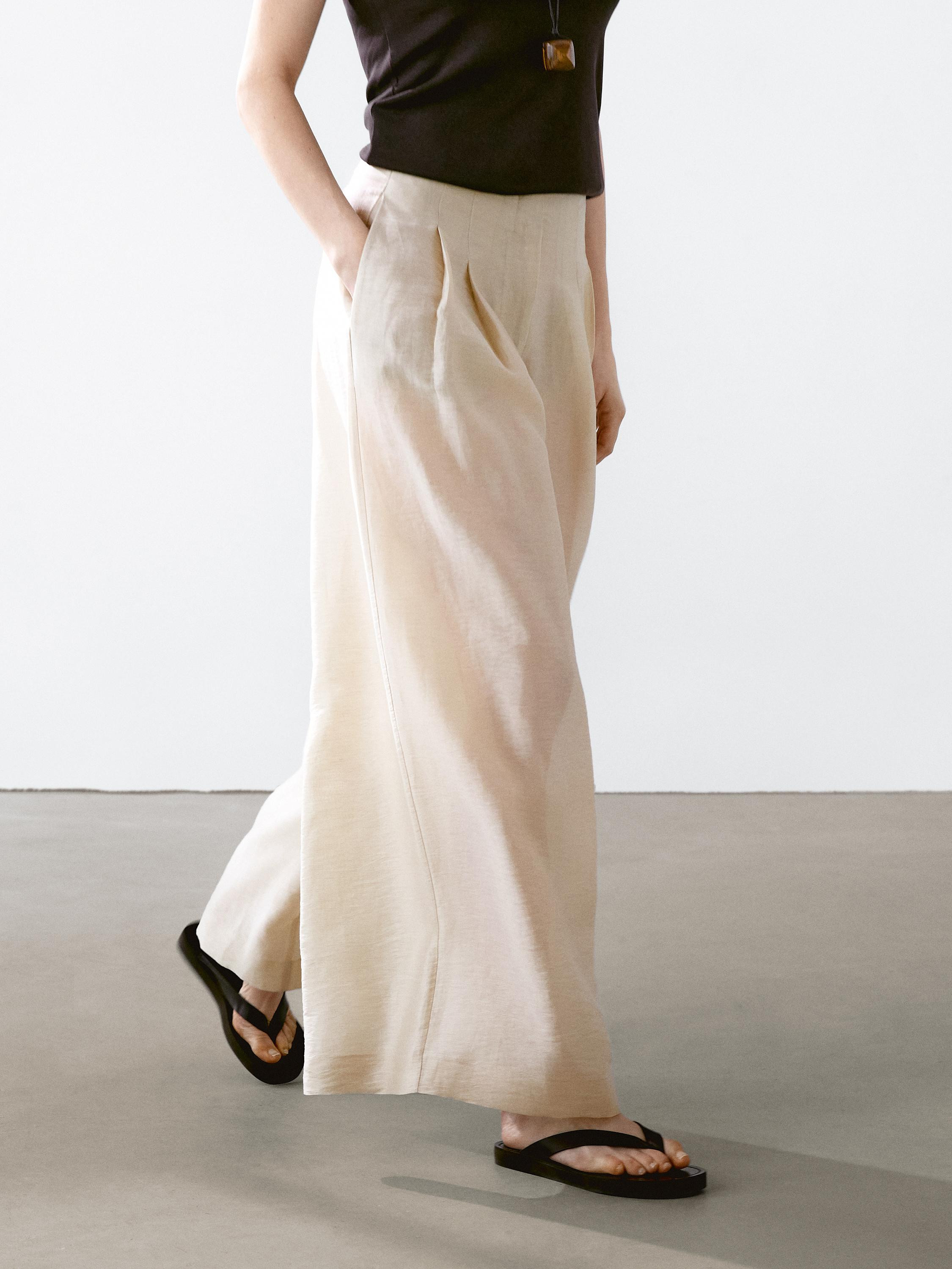 Trousers made of a linen blend fabric. Mid-waist. Zip fastening concealed by a placket, with hook... | Massimo Dutti UK