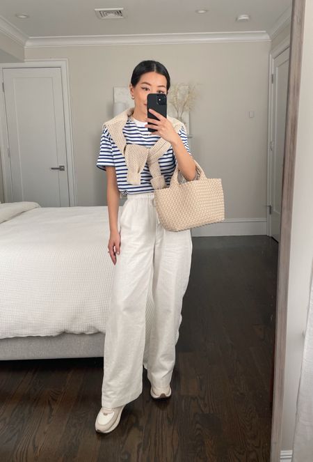 casual linen pants outfit with sneakers // petite linen pants 

•A+F linen blend pants xxs short 
•Striped tee xxs
•Madewell sneakers 5H
•Everlane sweater (old; similar linked)
•Naghedi tote bag

#petite vacation outfit ideas , warm weather style 

#LTKunder100 #LTKtravel #LTKsalealert