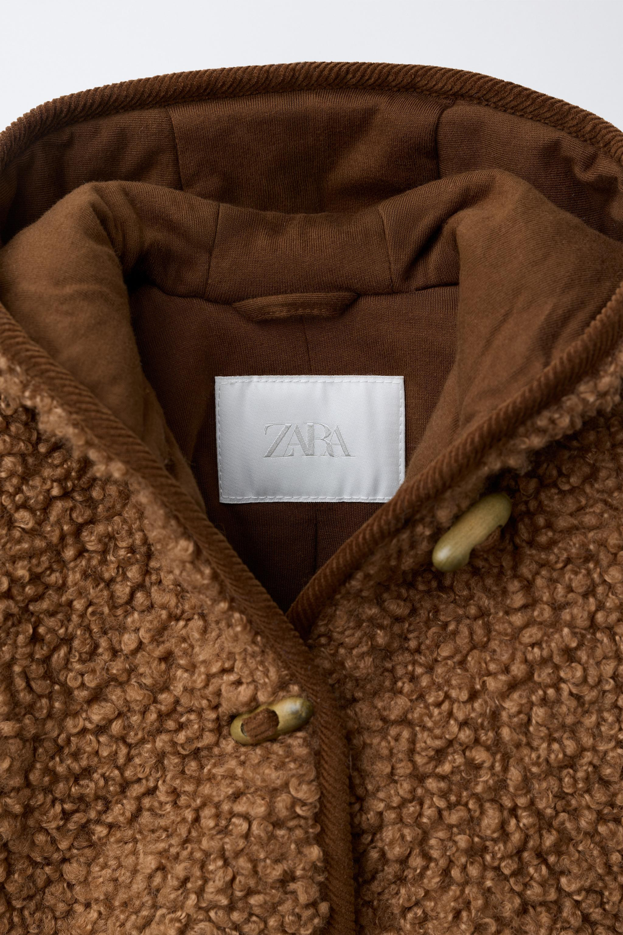 Faux shearling jacket with hoodie and long sleeves. Front fireman clasp closure. Polar fleece lin... | Zara US