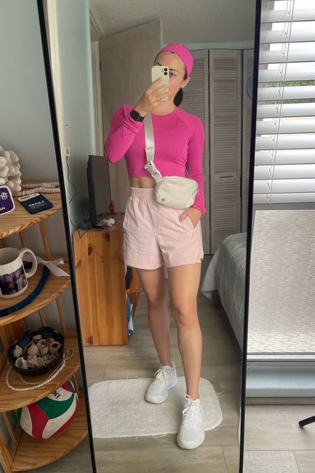 💖Barbie casual everyday outfit 🌟

Cute and comfy Athleisure look.  

lululemon Sonic Pink crop top and flush pink shorts.  Styled with my Everywhere Belt Bag in white opal and matching sneakers.  

The hair and is perfect for those no hair wash days!  