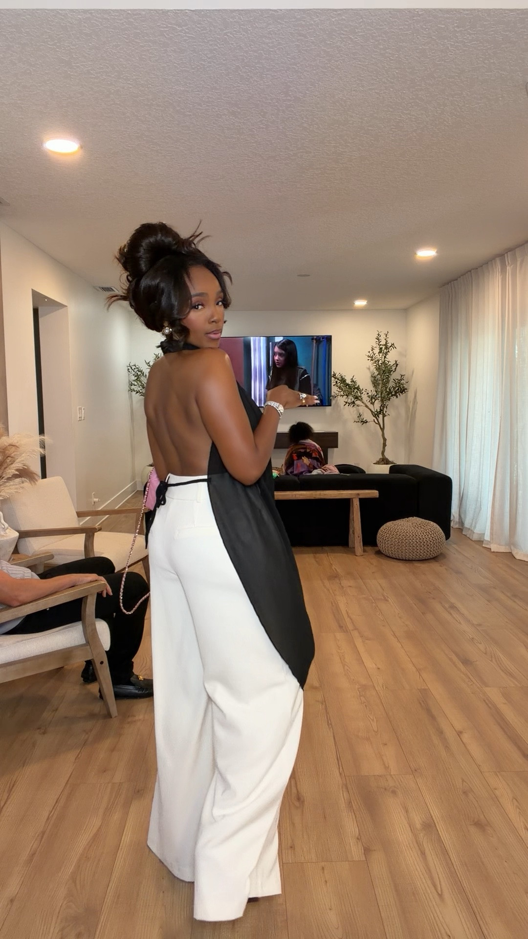 Hi Babes!

Okay this look is serving luxury from every angle. The dramatic black draped halter top paired with the crisp white trousers creates the most stunning contrast, and it honestly looks like something straight off a designer runway.

The top is the statement piece here. The draping is so flattering and elegant while still feeling modern and fashion-forward. Paired with the wide-leg trousers, it creates that effortless rich-girl aesthetic we all love. The pink bag adds the perfect unexpected pop of color.

Where to wear this:
• Upscale dinner dates
• Rooftop cocktails
• Fashion events
• Vacation evenings
• Special occasions when you want to turn heads

Accessories:
The pink quilted bag adds the perfect feminine touch, while delicate gold jewelry keeps the look elevated without taking away from the statement top.

Everything is linked below

xx Kira | IG: KirasFashionFinds

34D - 27 - 40 • Size Small or 4

#LTKootd #LTKPetite #LTKvlog