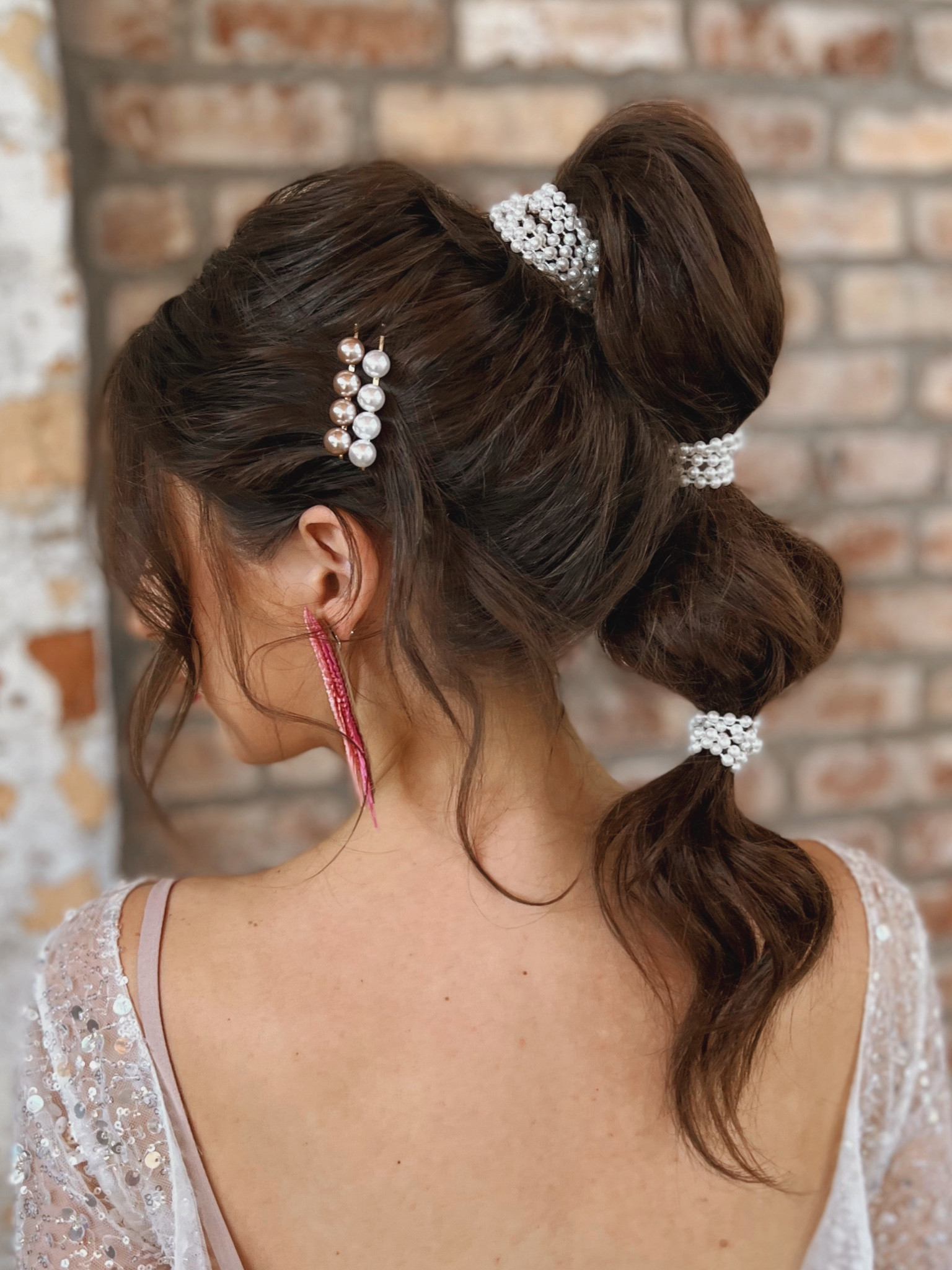 Pearl pins and strands of pearls created this bubble ponytail! Wrapping loose strands of pearls and pinning them into the elastics with mini bobby pins give an adorned pony, and adding in the two pearl pins accessorize the side style and add a little bit of whimsy so you’re photo ready from every angle. Perfect for a bachelorette party, wedding rehearsal, or a night out!

#LTKbeauty #LTKwedding