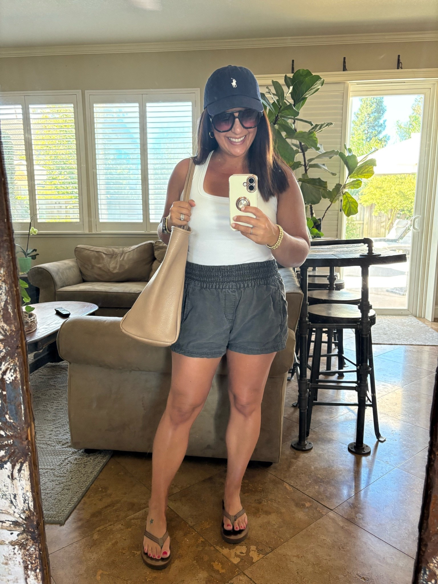 Full mom summer vacation mode today ☀️ Errands ✔️ Pool time ✔️ Hosting a sleepover tonight ✔️ This white tank is one of my favorite finds—it has a built-in bra (no extra sports bra needed 🙌), is so comfortable, and perfect for hot summer days. Paired it with my favorite easy shorts, flip-flops, and a baseball cap.

#LTKmomlife #LTKPetite #LTKSeasonal