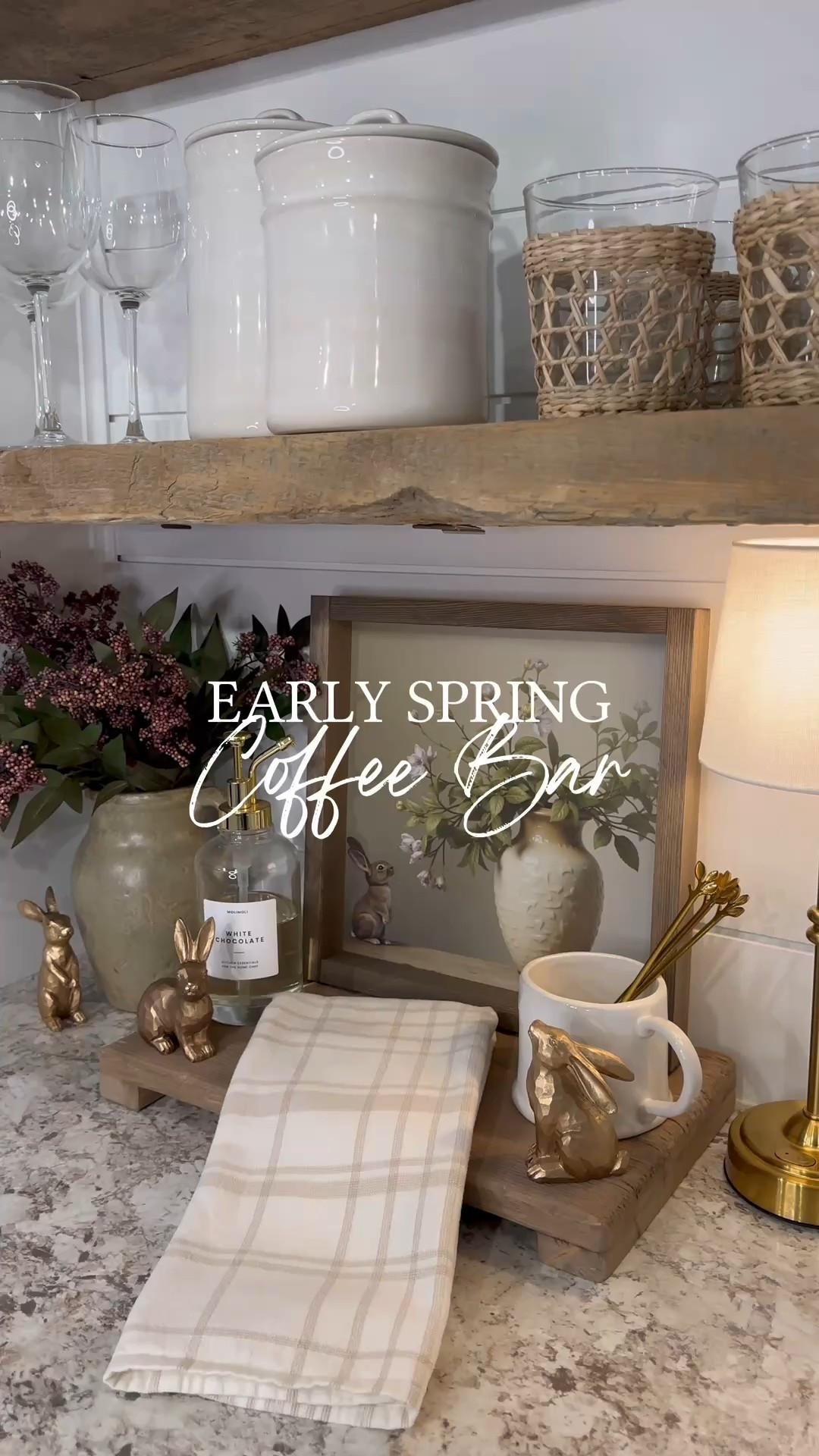 Early Spring Coffee Bar. Follow @farmtotablecreations on Instagram for more cozy home styling and seasonal finds.

This coffee bar is giving the prettiest early spring refresh 🤍 I styled the open wood shelves with simple glassware, neutral canisters, and woven textures to keep the space warm and inviting. The brass bunnies add a subtle seasonal touch, and the framed artwork brings everything together beautifully. Finished with a small lamp and folded linen towel for a collected, lived-in feel.

For reference:
• Artwork size 12x12 in Briarsmoke stain
• Code FARMTOTABLE for 15% off
• Wood riser size 16” x 9.25”
• One berry stem used

#coffeebar #kitchenstyling #openshelves #springdecor #neutralhome #brassaccents #countertopdecor #kitchendecor #shelves #homedecor

#LTKSaleAlert #LTKHome #LTKSeasonal