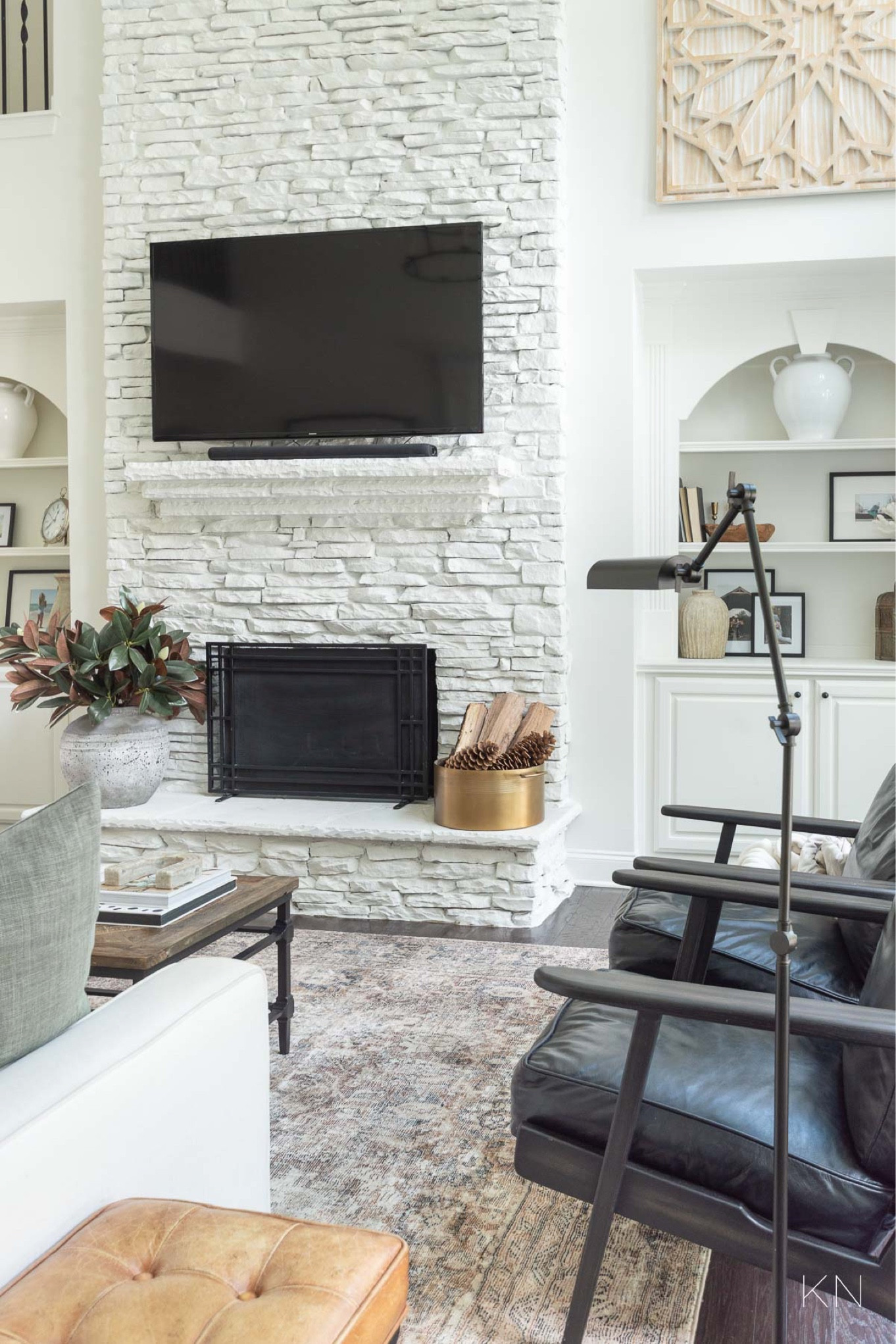 My neutral living room is styled simply for the season since the existing decor of wood tones, leather and earthy touches provide a warm and cozy feel for the cooler months. home decor living room decor neutral decor alabaster walls black leather armchairs stoneware vase large wood wall art brass party bucket fall decor

#LTKHome #LTKStyleTip #LTKSeasonal