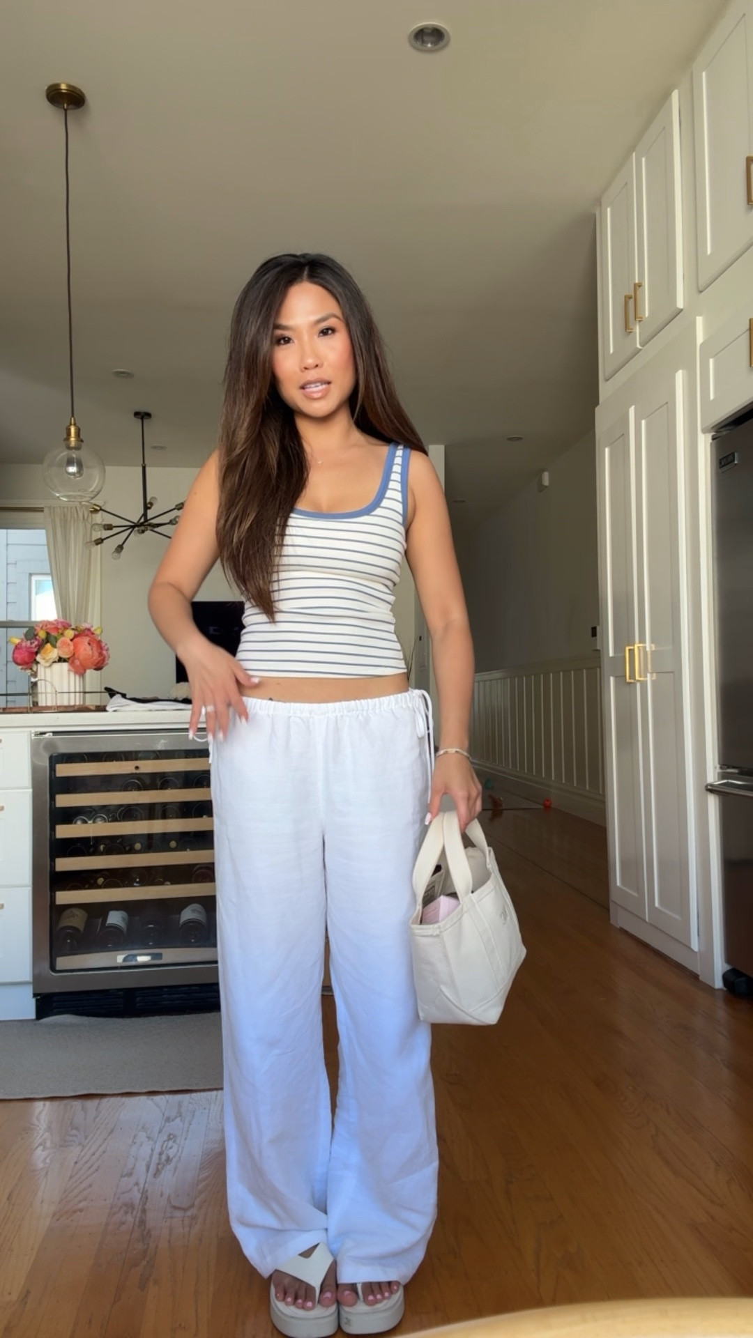 Summer ootd! Love these low rise linen pants and the side ties are so cute

Sizing:
Tank - tts, xs (on sale through today and you can stack code SHORTSAF)
Linen pants - tts, xs
Platform flip flops - tts
Mini boat and tote - mini size, natural color and natural letting in times bold initials for the monogram

#LTKSaleAlert #LTKPetite #LTKootd
