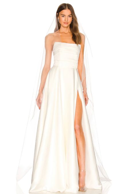 This strapless white wedding dress with a slit is stunning! You will love this wedding dress under $650.

#LTKwedding