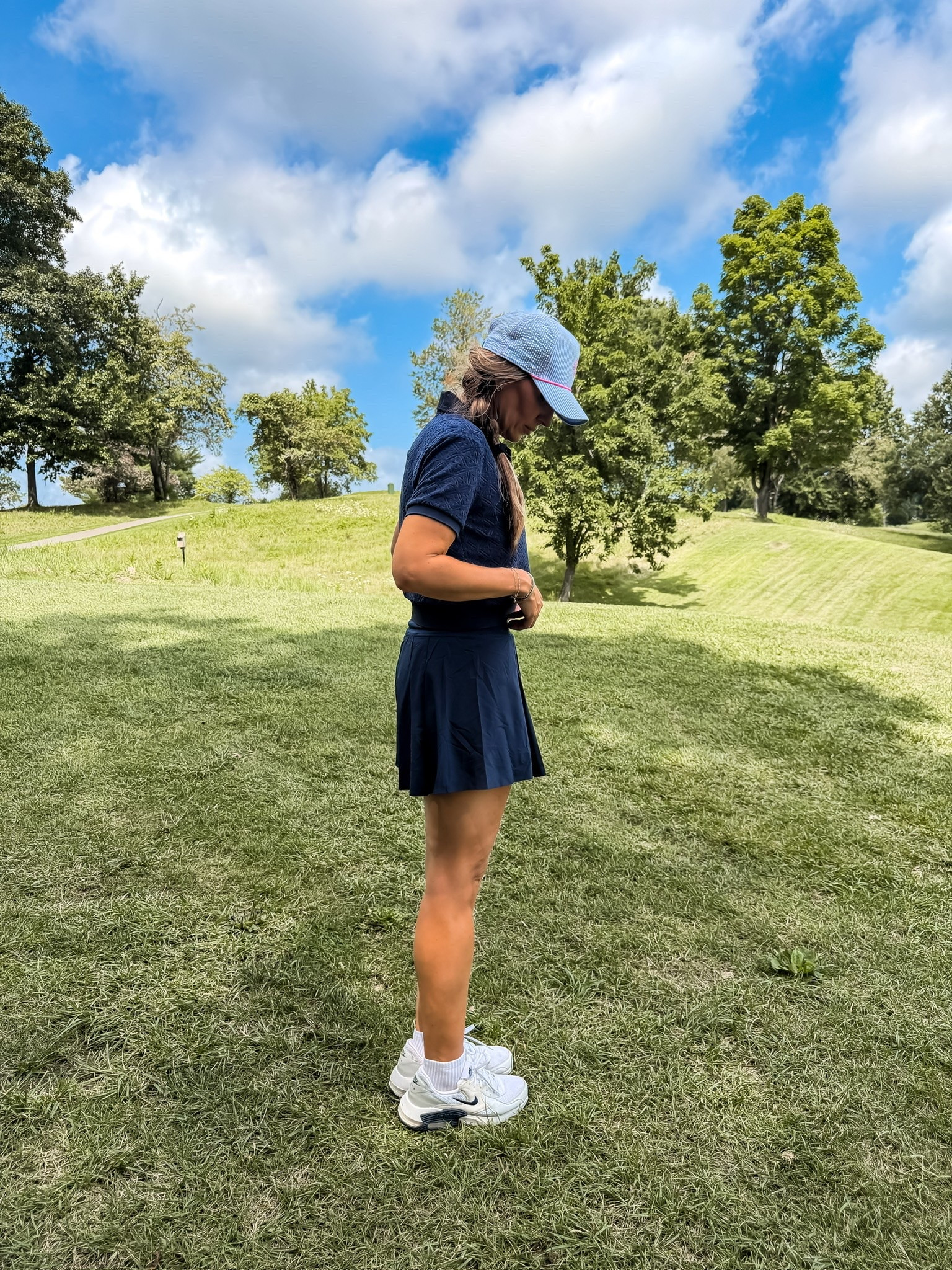 This golf outfit checks every box for a hot day on the course. The textured polo gives it a more elevated feel, the skort has plenty of stretch for moving comfortably, and the neutral sneakers keep the whole look practical from the first tee to the clubhouse.

golf outfit, golf skort, women’s golf apparel, golf polo, country club style, athletic outfit, golf fashion, sporty chic, golf shoes, TheMomInStyle

#LTKootd #LTKTravel #LTKOver40