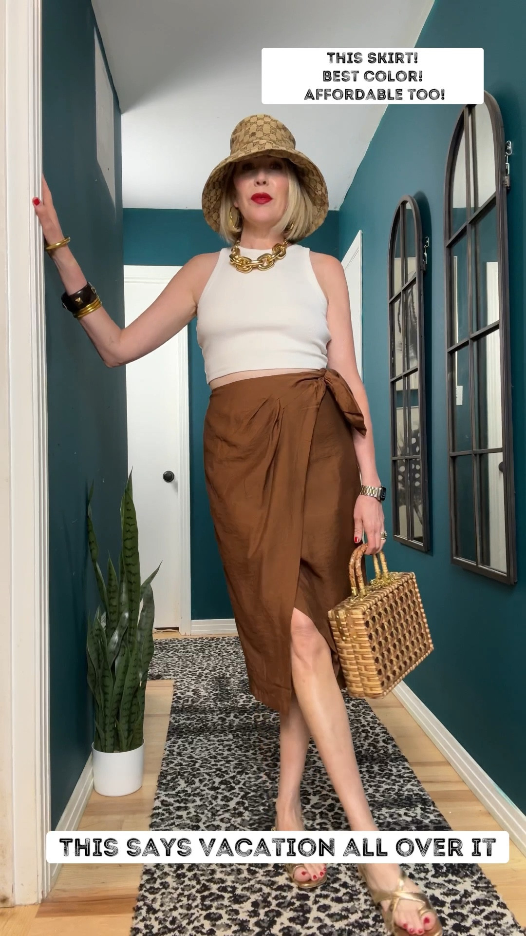 Affordable. Chic. And so comfortable. ✨

This skirt had me at the color—it’s the perfect rich cognac shade with a cute faux tie on the side that adds just enough detail. I paired it with a cropped cream tank because the skirt is high-waisted, and it hits just right without all that extra bunching you’d get from tucking in a longer top.

And when I say comfort… I mean it. These gold Naturalizer sandals are not only adorable, but they also look way more expensive than they were! I finished the look with:
✨ A chunky gold chain necklace
✨ Stacked bracelets
✨ And my favorite hat of the season

Proof you don’t have to spend a fortune to look put together. Would you wear this look?
#VacationOutfit #SummerSkirt #SummerHat #

#LTKShoeCrush #LTKOver40 #LTKTravel