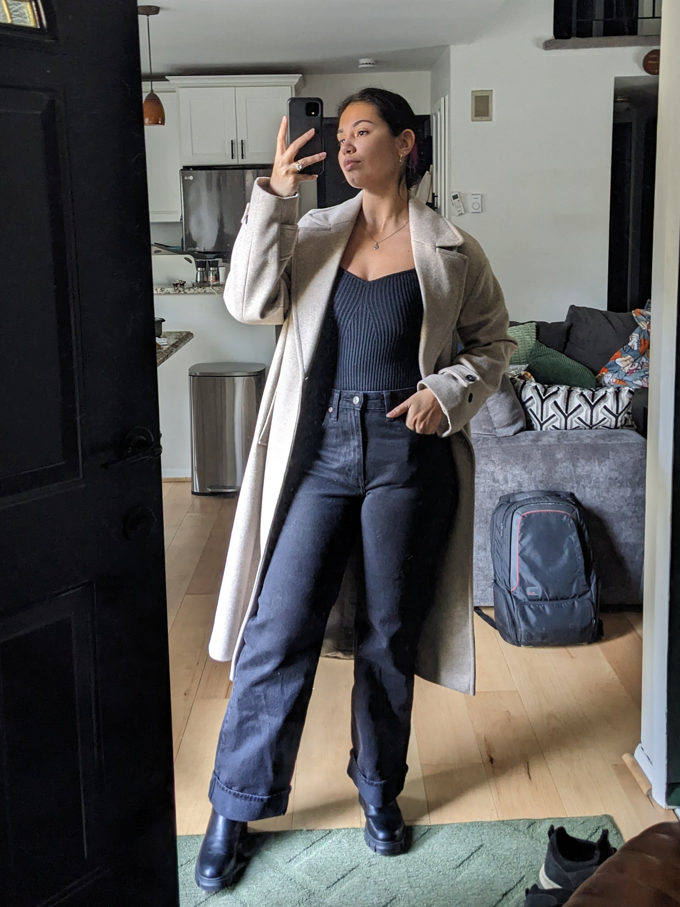 All black base outfit and chelsea boots with a taupe trench coat 

#LTKWorkwear