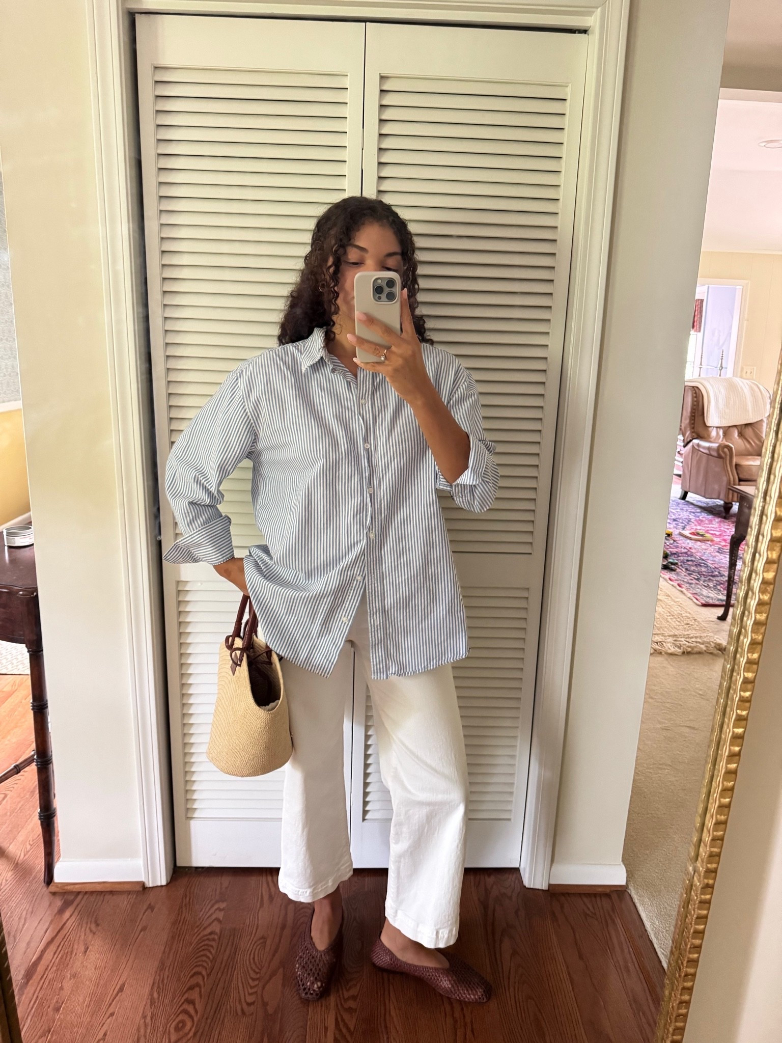 Preppy summer outfit: oversized blue and white button up, white jeans, straw bag, woven flats

#LTKootd