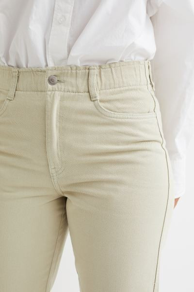 Conscious choice  Ankle-length, 5-pocket pants in cotton twill. High waist and ruffle-trimmed wai... | H&M (US + CA)