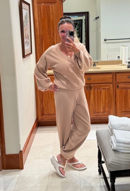 Bell sleeve deep v-neck sweater and matching sweater jogger. Perfect for lazy days. No makeup, wet hair in a bun, and a jogger set. 
kimbentley, loungewear, jogging pants, sandals, travel outfit

#LTKfindsunder100 #LTKActive #LTKtravel