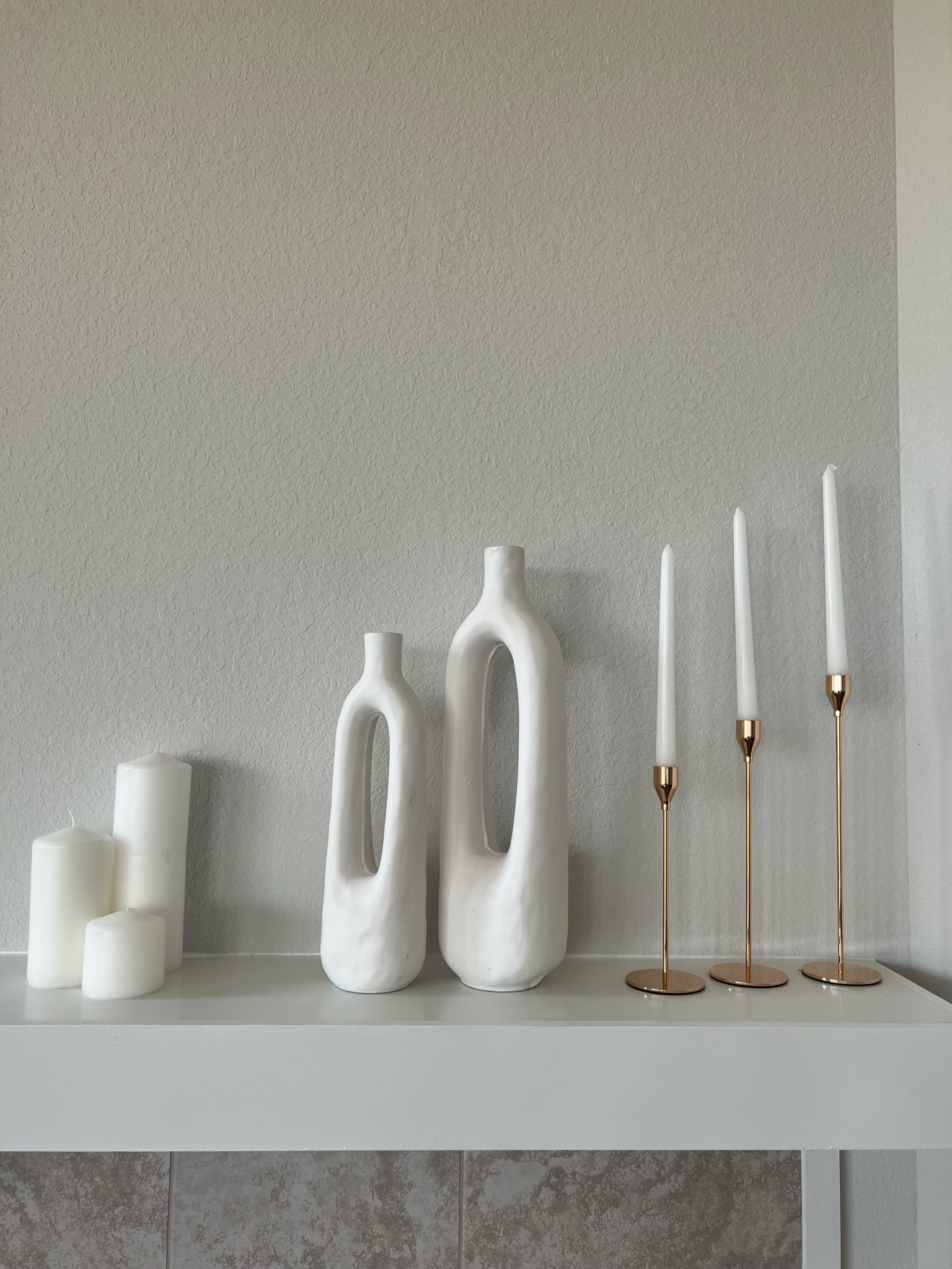 Minimalist home decor. Gold candle holder, taper candles, pillar candles 

#LTKunder50 #LTKFind #LTKhome
