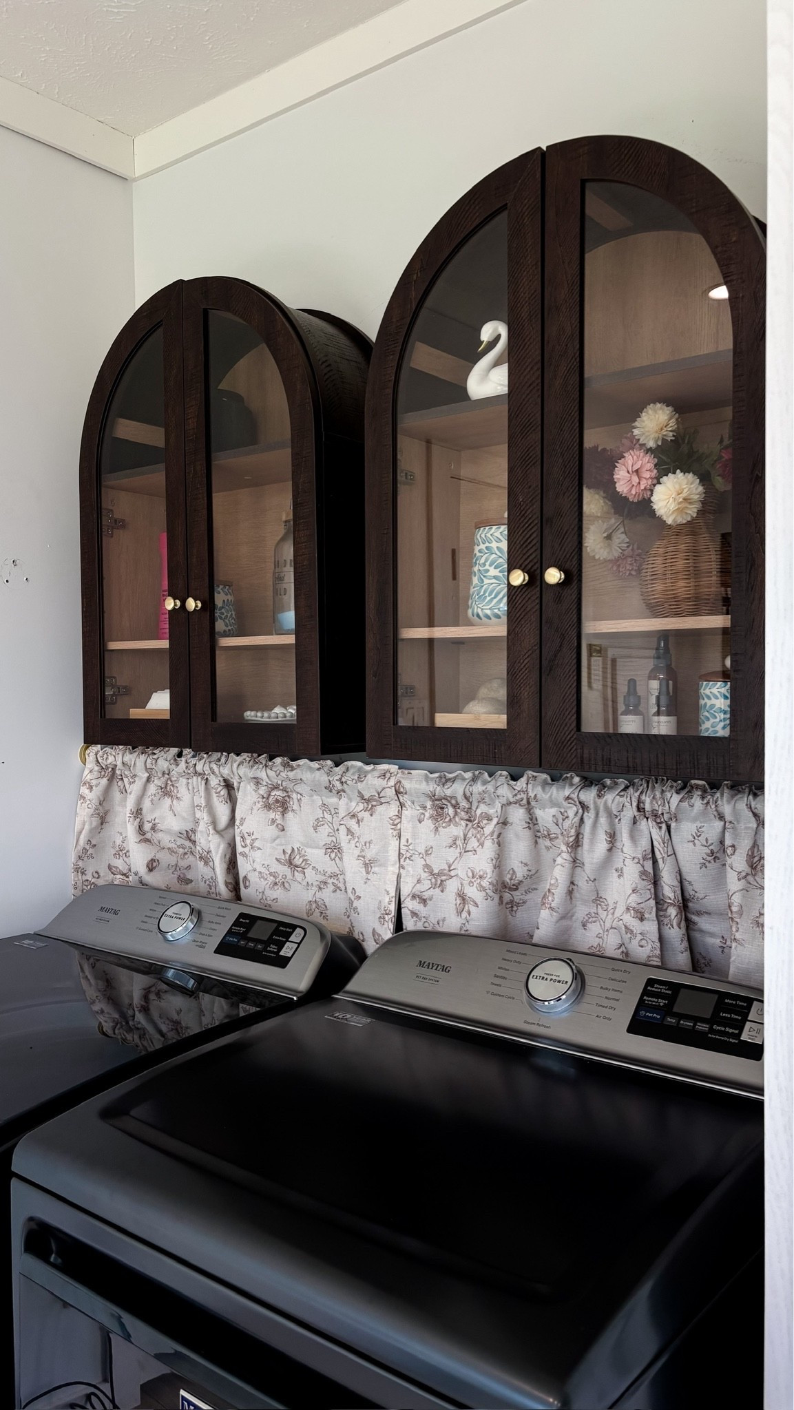 I’ve had the same arched cabinet over the toilet in my guest bathroom and I always get so many compliments from guests! Love the curtains to hide the hook ups too!!