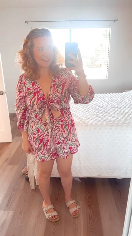 Cutest floral romper! 🌸 Perfect for curvy gals headed to the beach for Spring/Summer. 

50% off right now - under $50. 

Emma is wearing a size L - this one piece tie-front romper does fit TTS. It’s so comfortable and adorable. ✨ She paired with her affordable everyday faux birks! 

Vacation outfit, romper, curvy outfit, midsize, 

#LTKmidsize #LTKfindsunder50 #LTKsalealert