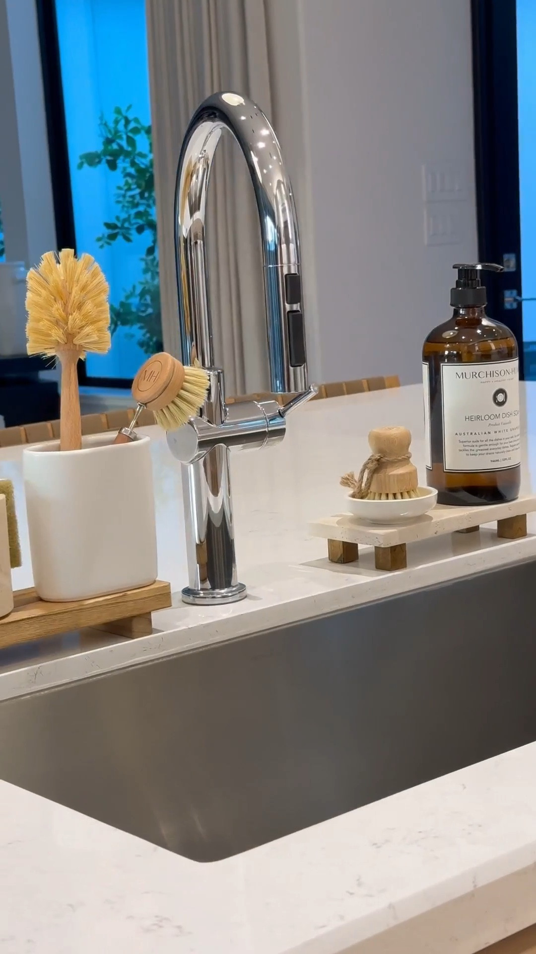 Kitchen Sink Essentials: 

Wooden & travertine risers 
Dish sponge holder 
Brush holders
Glass, pot, and dish brushes
Dish soap 
#LTKStyleTip 

#LTKSaleAlert #LTKHome