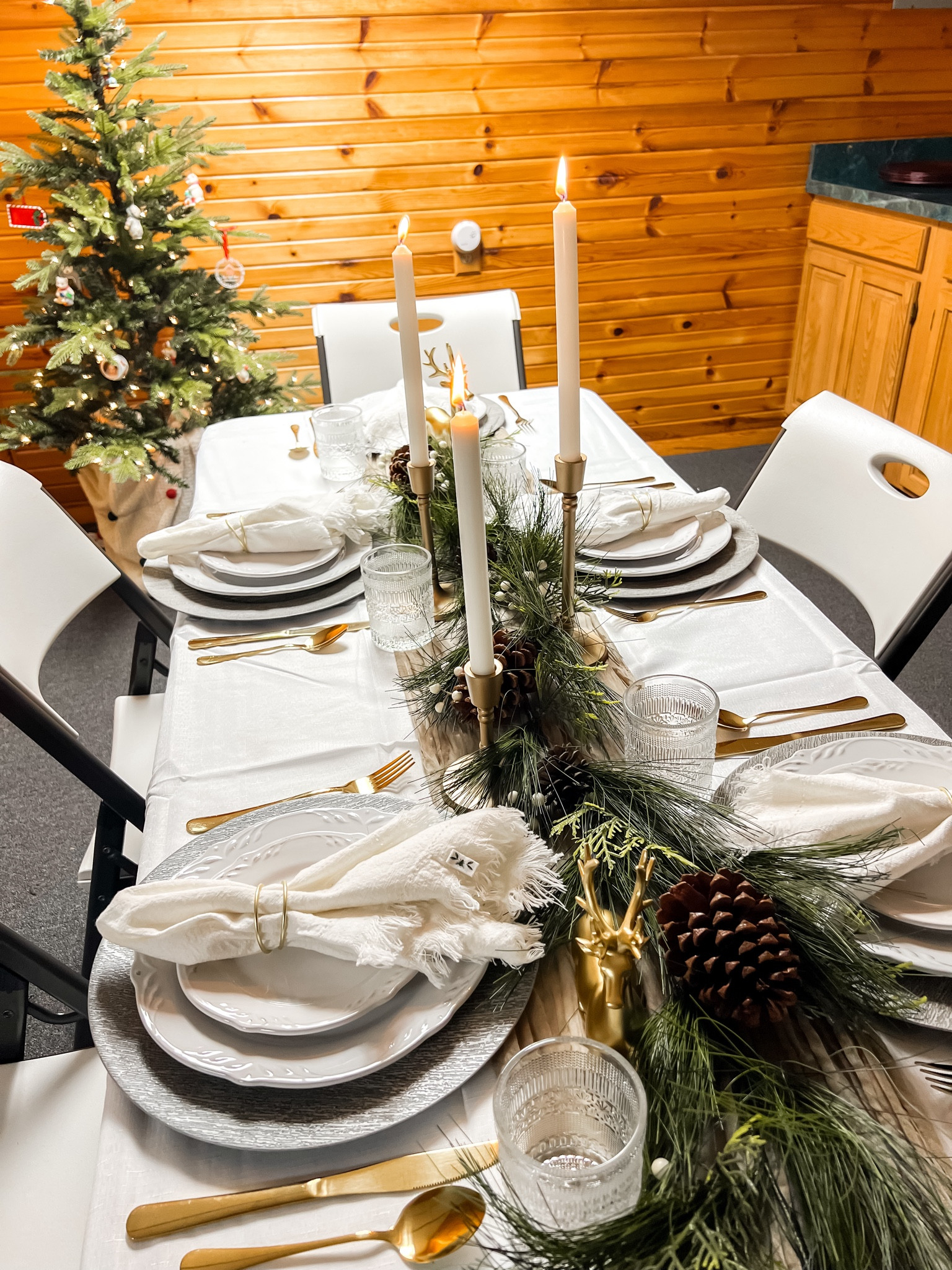 Easy affordable Christmas table setting with gold silverware and greenery 

Christmas dinnerware, Christmas garland, candle stick holders, gold reindeer, Christmas decor 

#LTKSeasonal #LTKHoliday #LTKparties