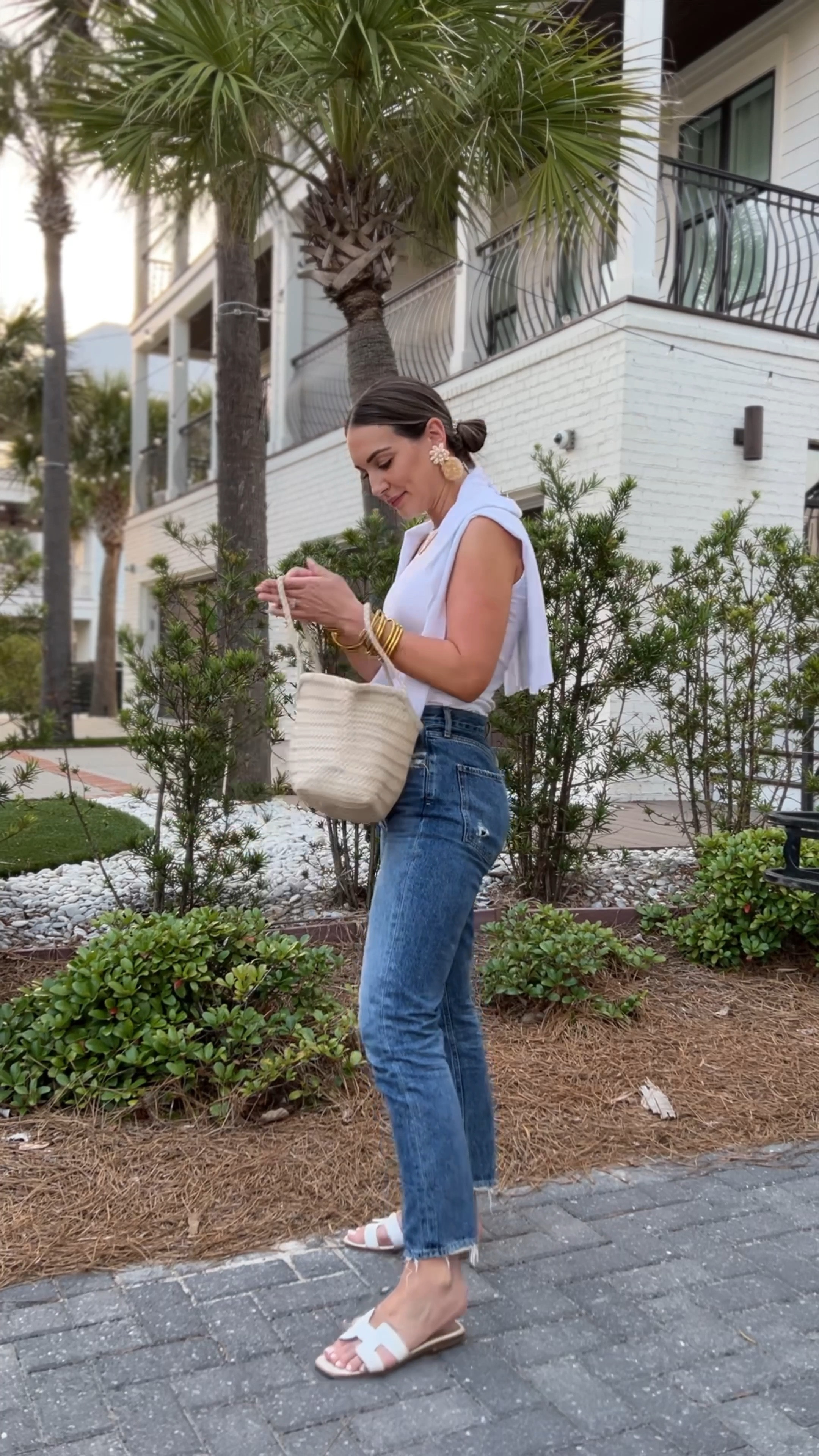 The most classic summer no-fail outfit.

Sleeveless tee, classic agolde jeans, Amazon shoulder sweater, leather woven bag, white sandals, raffia earrings 

#LTKstyletip