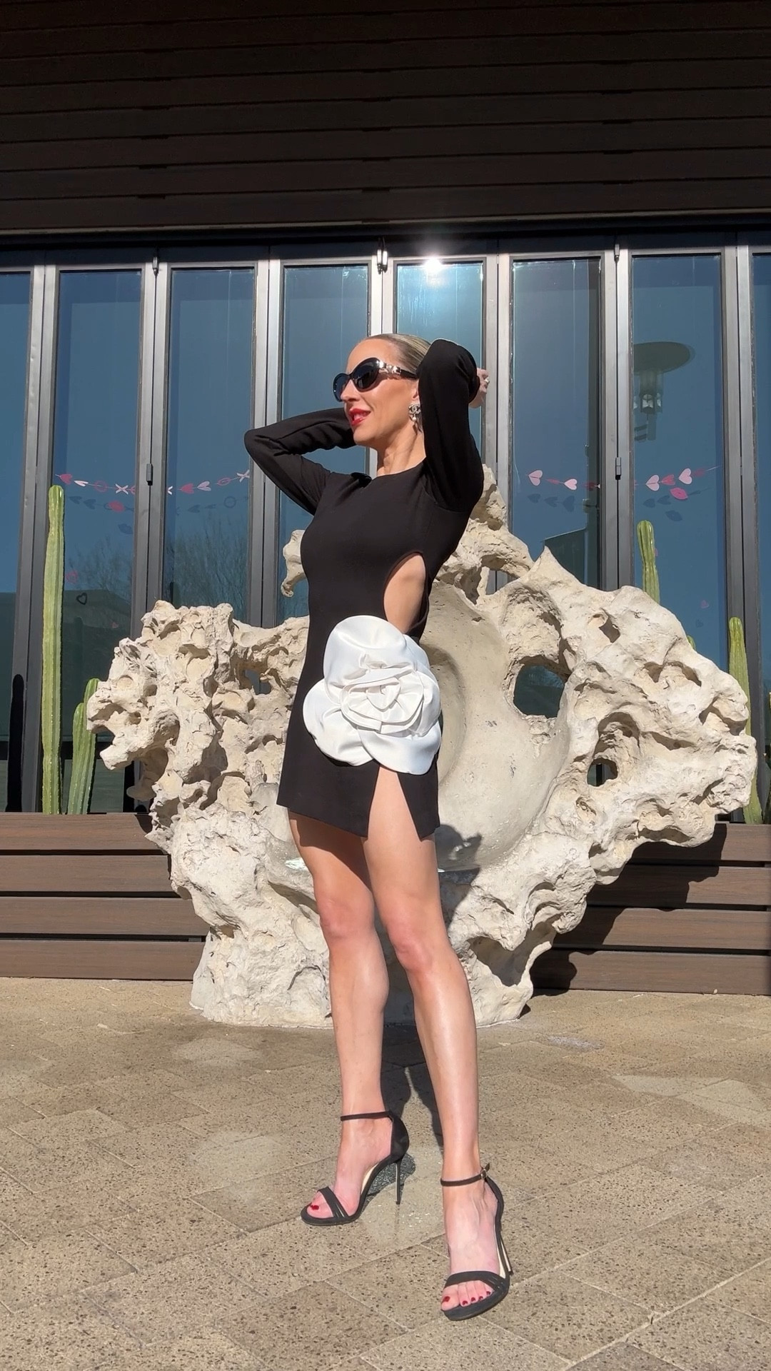 Valentine’s Day outfit idea / Valentine’s Day dress - black long sleeve mini dress with sexy cut out and oversized 3D flower, black strappy heels and a red lip for a femme fatale look 💕 

#LTKStyleTip #LTKWatchNow #LTKSeasonal