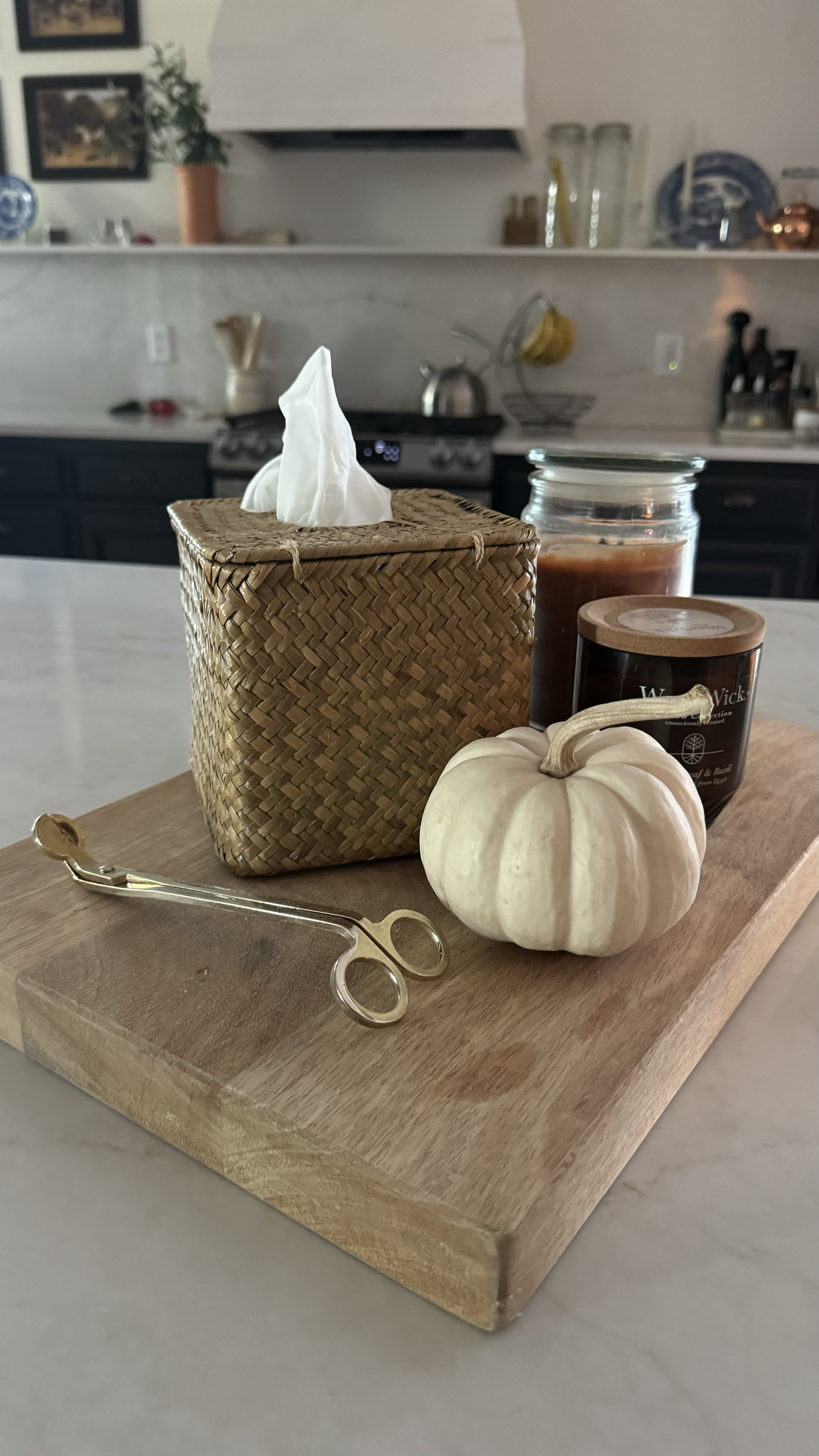 Cutting board used as our tissue and candle holder on the kitchen island 🪴